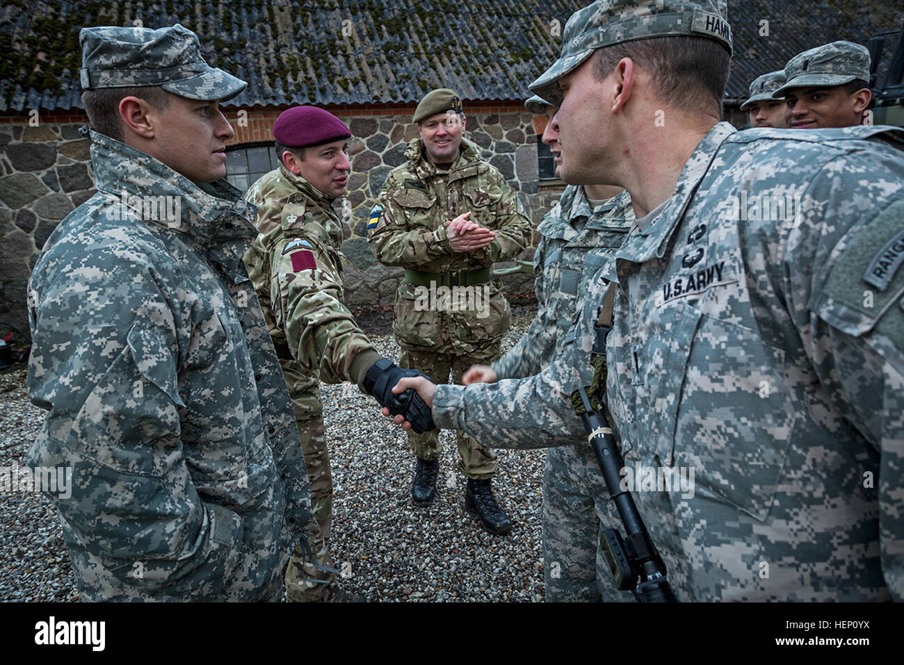 Paratroopers from Company B, 1st Battalion, 503rd Infantry Regiment , 173rd Airborne Brigade, shake hands with British soldiers from Queens Company, Grenadier Guards, during Exercise White Sword here, Dec. 8 2014. Exercise White Sword is a multinational exercise involving over 1500 NATO troops from Denmark, the United Kingdom and the U.S., and designed increase interoperability between allied forces and certify the Danish 2nd Brigade RBG for the 2015 NATO Reaction Force. (U.S. Army Photo by Sgt. Benjamin John) Exercise White Sword 141208-A-DS355-073 Stock Photo