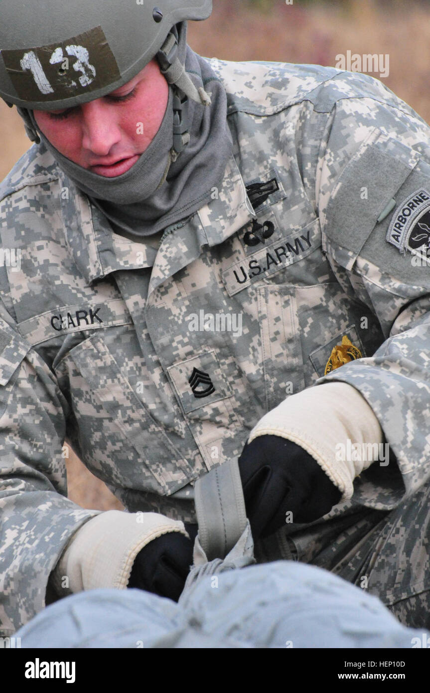 Sgt. 1st Class Rob Clark, from Charlie Company, 3rd Battalion, 1st Special Warfare Training Group (Airborne), recovers his parachute after a jump at Luzon Drop Zone, Camp Mackall, N.C., for the 17th Annual Randy Oler Memorial Operation Toy Drop, hosted by U.S. Army Civil Affairs & Psychological Operations Command (Airborne), Dec. 8, 2014. Operation Toy Drop is the world’s largest combined airborne operation and allows Soldiers the opportunity to help children in need receive toys for the holidays. (U.S. Army photo by Spc. Lisa Velazco) US Army paratrooper recovers parachute 141208-A-QW291-270 Stock Photo