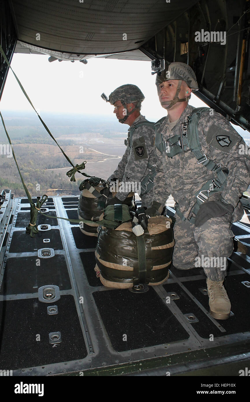Army Guardsmen prepare to drop door bundles out of a