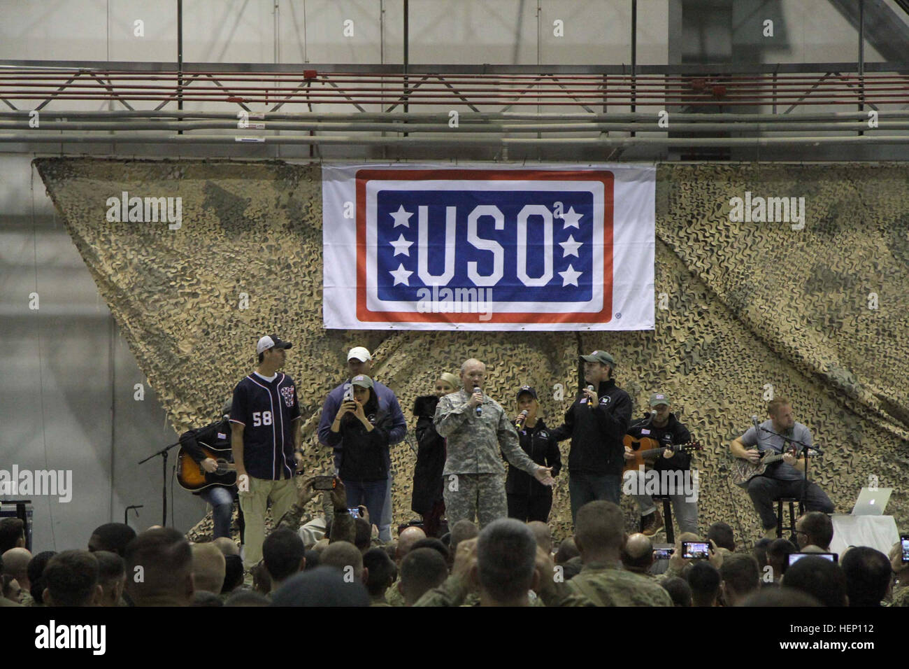 The Chairman of the Joint Chiefs of Staff, Gen. Martin E. Dempsey, sings “White Christmas” with the military service members stationed at Bagram Air Field, Afghanistan, Dec. 9. 2014. Dempsey was joined on his USO Holiday Troop Tour, by Country music artist Kellie Pickler, retired Chicago Bears middle linebacker Brian Urlacher, actress Dianna Agron, comedian Rob Riggle, actress Meghan Markle, Washington Nationals pitcher Doug Fister and USO President Dr. J.D. Crouch II. (U.S. Army Photo by Sgt. Adam Erlewein, 4RSSB Public Affairs.)(Released) Gen. Dempsey spreads holiday joy 141209-A-AE663-254 Stock Photo