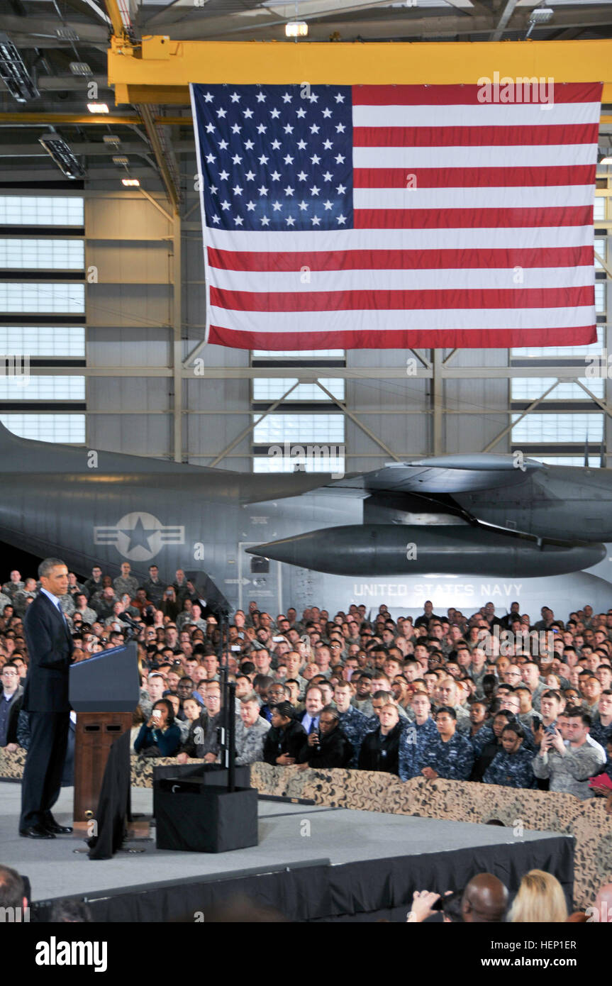 U.S. President Barack Obama speaks to an audience of 3,000 service members, military families, civic leaders and elected officials Dec. 15 inside a U.S. Marine hangar on Joint Base McGuire-Dix-Lakehurst, N.J. The purpose of the president’s visit to JB MDL was to thank troops for their service. Also speaking at the event were Maj. Gen. Margaret W. Boor, commanding general of the Army Reserve’s 99th Regional Support Command, and Maj. Gen. Rick Martin, commanding general of the U.S. Air Force Expeditionary Center. President Obama thanks troops at New Jersey's Joint Base MDL 141215-A-VX676-039 Stock Photo
