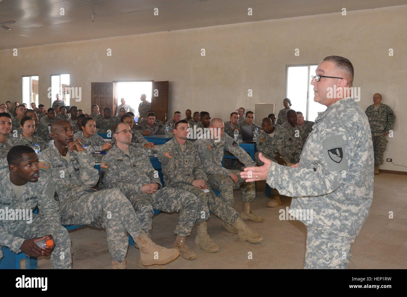 Chaplain Maj. Alfred Grondski, right, a Trenton, N.J., native, of Headquarters and Headquarters Brigade, 36th Engineer Brigade, briefs Soldiers about redeployment stresses they might endure when they get home, during the Operation United Assistance mission, at the National Police Training Academy, Payenesville, Liberia. Dec. 31, 2014. Grondski said his mission here is to provide spiritual support to the Soldiers that are on their way home. Operation United Assistance is a Department of Defense operation in Liberia to provide logistics, training and engineering support to U.S. Agency for Intern Stock Photo