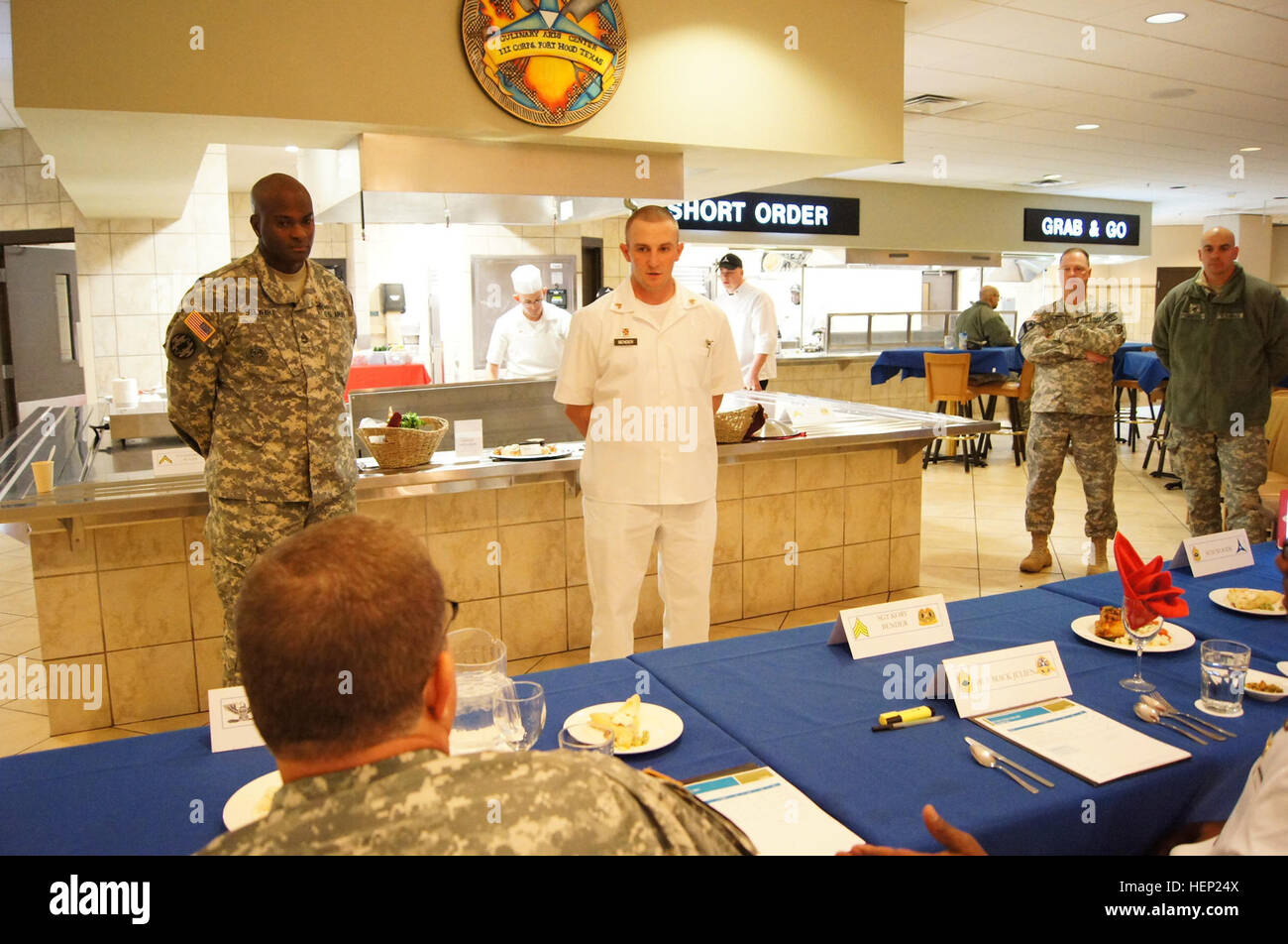 Sgt. Kory Bender, Alpha Company, 40th Expeditionary Signal Battalion, 11th Signal Brigade, listens to the judges as they critique his dishes during the competition. Bender left Fort Huachuca to compete in the Culinary Arts Noncommissioned Officer of the Quarter board at Fort Hood, Texas, Jan. 7. After winning the board, he went on to the Culinary Arts NCO of the Year competition Jan. 8–9. (U.S. Army photo by Staff Sgt. Kelvin Ringold) Sergeant cooks up a win at Culinary Arts of Quarter board 150109-A-HT688-473 Stock Photo