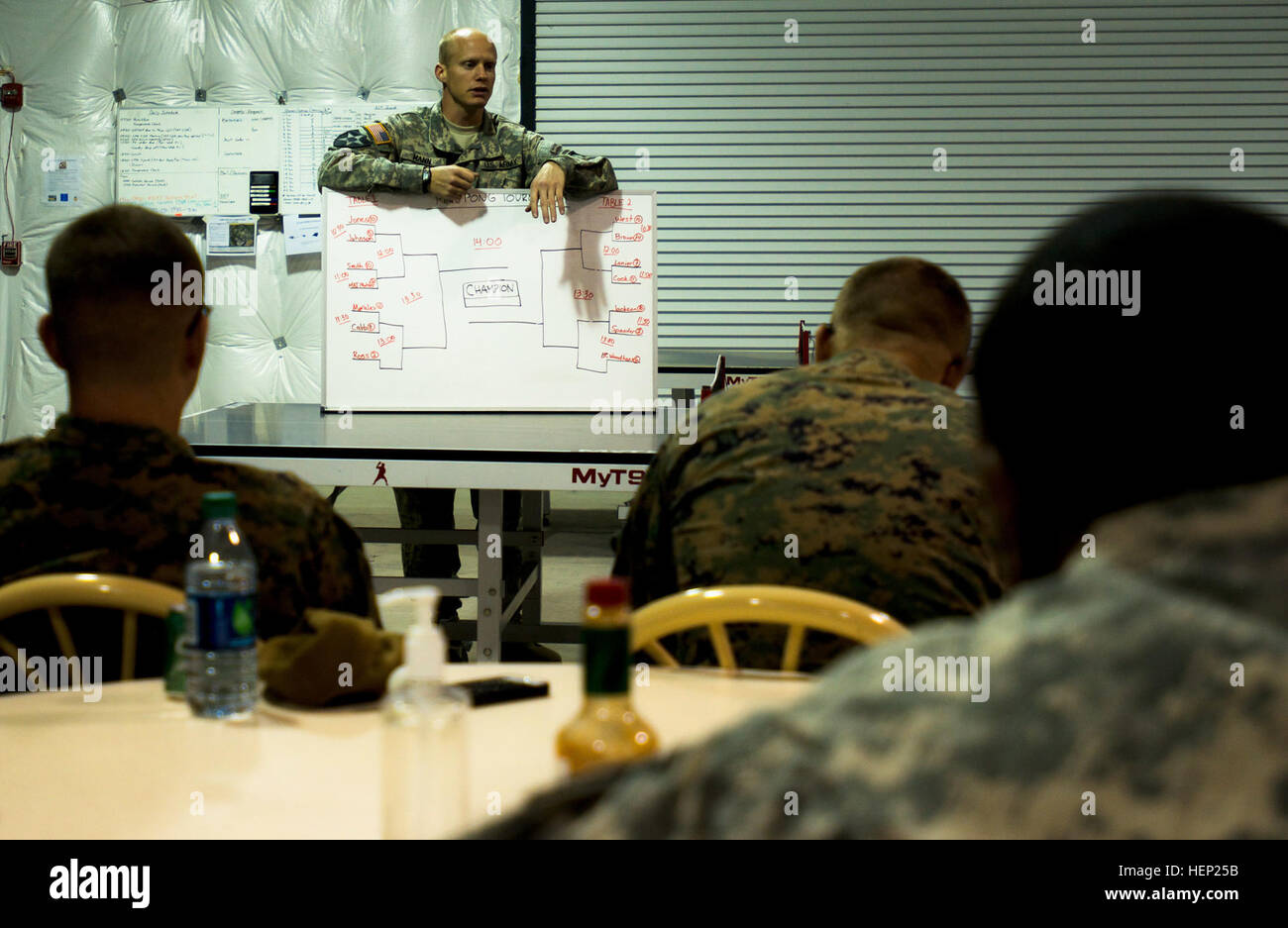 Capt. David Mann, intelligence officer, Headquarters and Headquarters Battalion, 101st Airborne Division (Air Assault), explains the rules for a table tennis tournament being held for service members who recently returned from Liberia in support of the U.S. Agency for International Development–led mission, Operation United Assistance, Joint Base Langley Eustis, Va., Jan. 10, 2015. This is one of many games that Mann has organized for the troops undergoing the 21-day controlled monitoring. The others include basketball, flag football and weight lifting. OUA is a Department of Defense operation  Stock Photo