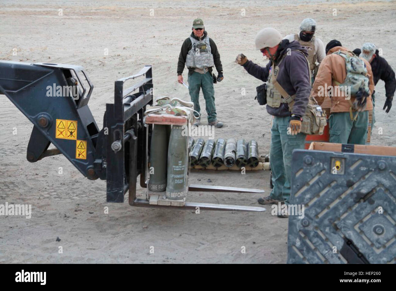 Explosive ordnance and ammunition technicians from the Joint Munitions Destruct-Afghanistan Team prepare the nearly 6,000 pounds of small arms, artillery rounds, mortars and 2.75 inch rockets for demolition at an undisclosed location near Bagram  Air Field, Afghanistan, Jan. 10, 2015. The Class H or out dated munitions were being blown up as part of the U.S. DEMIL mission in support of Operation Resolute Support. (Photo by Sgt. 1st Class Chris Bridson, 4RSSB. PAO, 13th ESC. Released) Wranglers support DEMIL operations 150110-A-CB576-159 Stock Photo