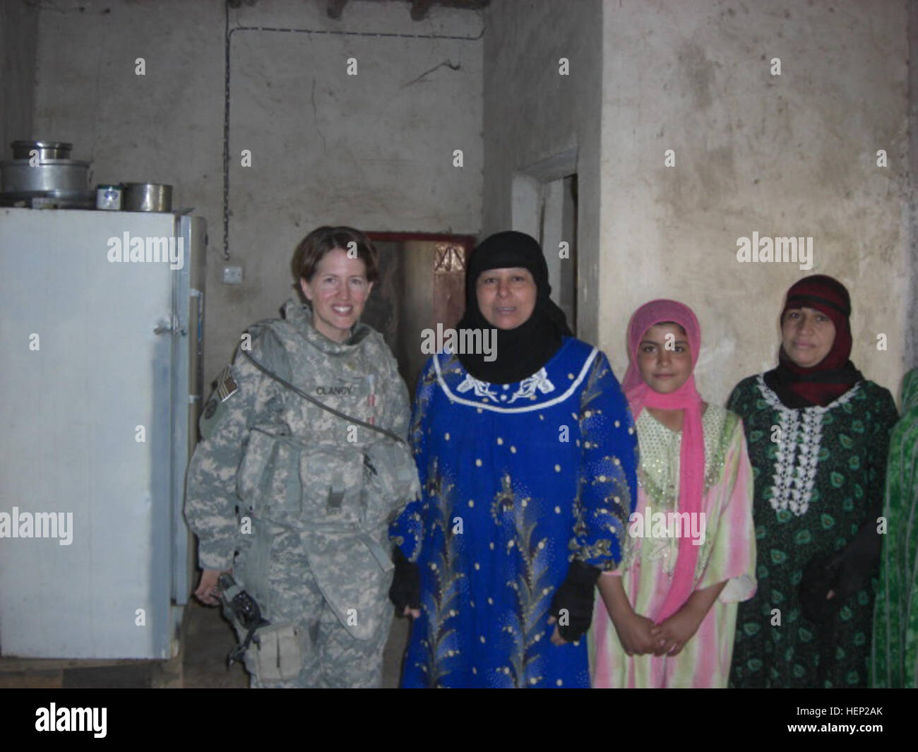 Lt. Col. Hailey Clancy, of Mesa, Ariz., 2nd Brigade Combat Team, 1st Armored Division, Multi-National Division - Baghdad, meets with Iraqi women in Jisr Diyala, Iraq. Clancy and her husband, Maj. Mike Clancy, of the Bronx, N.Y., are one of numerous couples in the Iron Brigade who are dual military and deployed together. 'It's nice because we have no roommate issues,' said Clancy with a smile. For Better and for Worse, Iron Brigade Couple Stay Close Even in Times of War 164729 Stock Photo