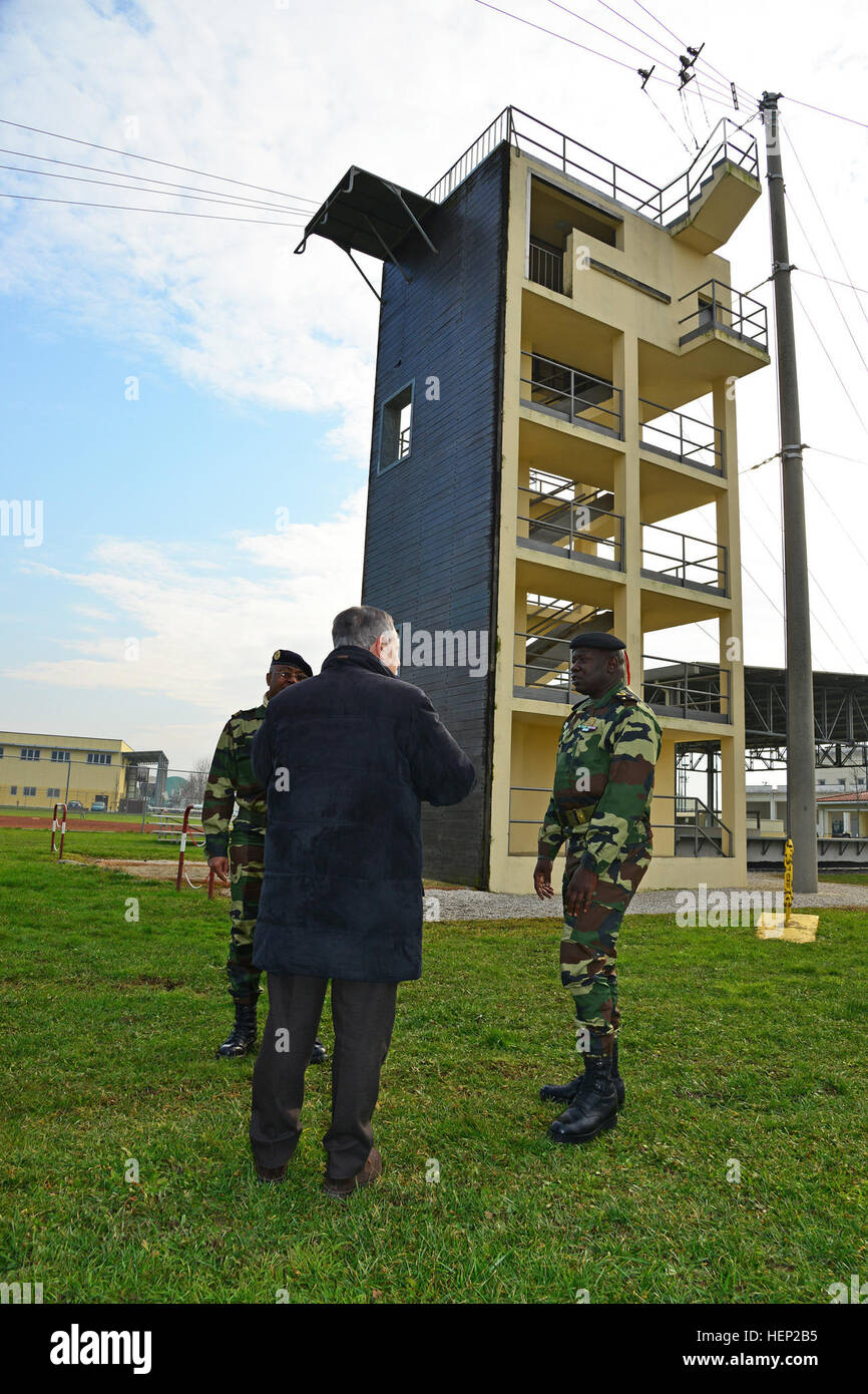Ivano Trevisanutto, chief, Training Support Center Italy (right), explains the 34-foot jump tower operations and capabilities to Brig. Gen. Cheikm Gueye, Senegalese chief of army staff (right), and delegation during the visit at Caserma Ederle, Vicenza, Italy, Jan. 14, 2015. (Photo by Visual Information Specialist Paolo Bovo/Released) Senegalese Chief of Army Staff Brig. Gen. Cheikm Gueye tours Regional Training Support TSAE Vicenza, Italy, at Caserma Ederle 150114-A-JM436-055 Stock Photo