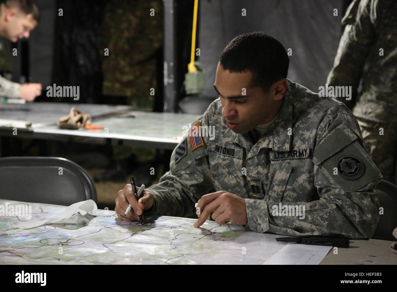 U.S. Army Capt. Nicholas Antonio of 2nd Cavalry Regiment, the brigade engineer officer, updates a map in preparation for a course of action brief during exercise Allied Spirit at the Joint Multinational Readiness Center in Hohenfels, Germany, Jan. 23, 2015. Exercise Allied Spirit includes more than 2,000 participants from Canada, Hungary, Netherlands, United Kingdom, and the U.S. Allied Spirit is exercising tactical interoperability and testing secure communications within Alliance members. (U.S. Army photo by Sgt. Gemma Iglesias/Released) Allied Spirit I 150123-A-QC664-001 Stock Photo