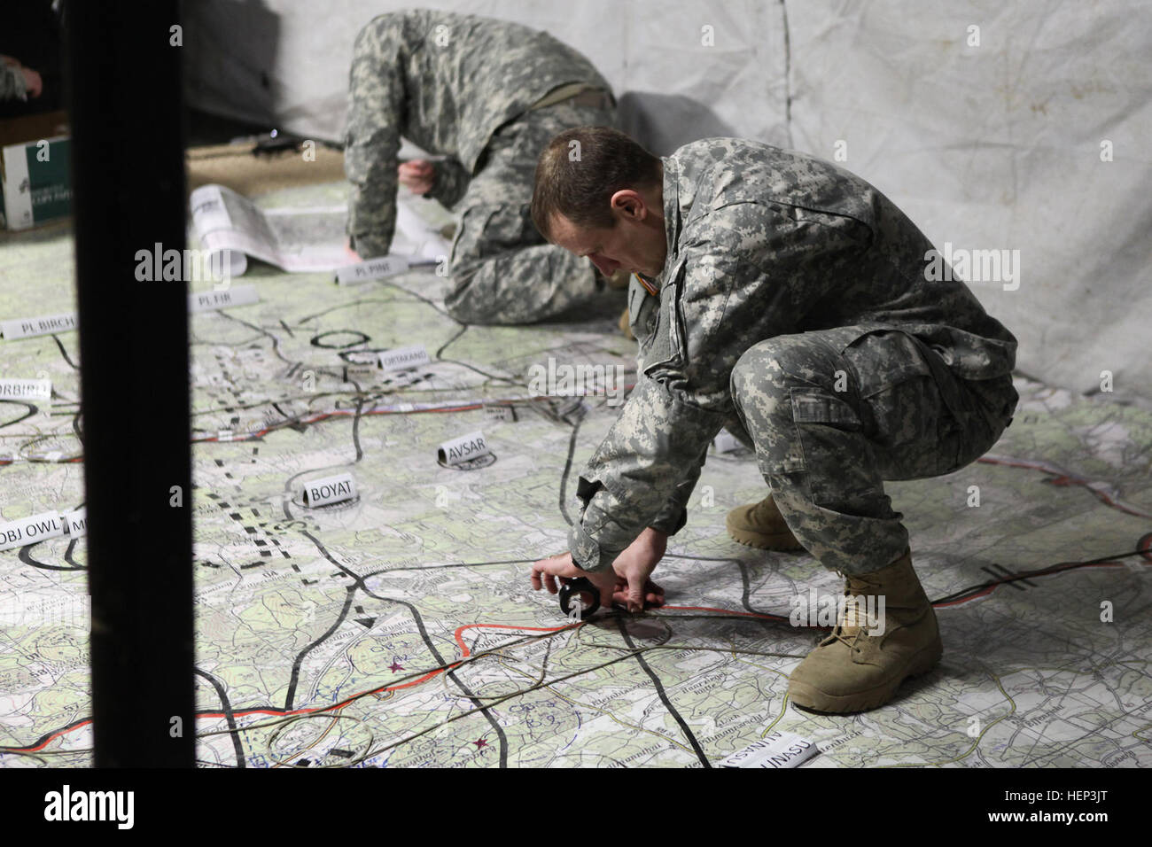A U.S. Soldier of 2nd Cavalry Regiment marks a map while conducting an intelligence collection rehearsal during exercise Allied Spirit at the Joint Multinational Readiness Center in Hohenfels, Germany, Jan. 25, 2015. Exercise Allied Spirit includes more than 2,000 participants from Canada, Hungary, Netherlands, United Kingdom, and the U.S. Allied Spirit is exercising tactical interoperability and testing secure communications within alliance members. (U.S. Army photo by Pfc. Lloyd Villanueva/Released) Allied Spirit I 150125-A-WG858-001 Stock Photo