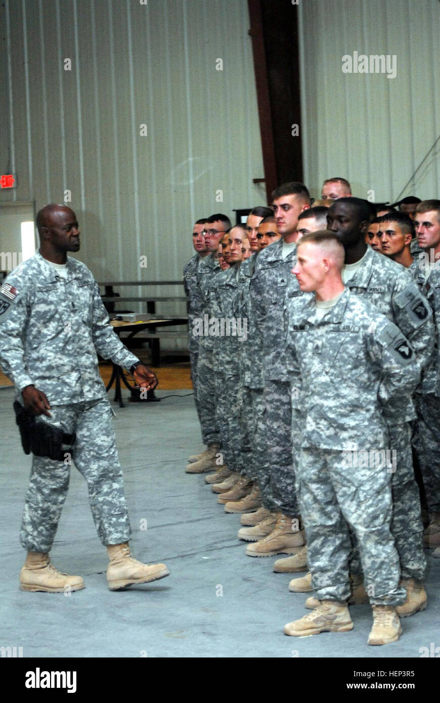 Command Sgt. Maj. Bernard McPherson, native of Orangeburg, S.C., and command sergeant major of the 18th Military Police Brigade addresses 74 newly inducted non-commissioned officer s of the 716th Military Police Battalion, 18th MP Bde., Multi-National Division-Baghdad, into the Corps of NCOs June 21 at Camp Liberty during an NCO induction Ceremony. The 716th MP Bn. is deployed from Fort Campbell, Ky. Maintaining the standard in Iraq 96056 Stock Photo