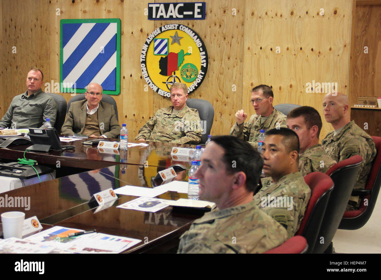 Col. Cameron Cantlon (center right), the Train, Advise, Assist Command – East Deputy Commanding Officer uses a laser pointer to highlight locations on a map of eastern Afghanistan to U.S. Ambassador to Afghanistan P. Michael McKinley (center left) during a meeting with TAAC-E leaders and staff at Tactical Base Gamberi Feb. 11, 2015. McKinley visited TAAC-E to gain an assessment of the transition from Operation Enduring Freedom to NATO’s new Resolute Support Mission and discuss progress of Afghan National Security Forces in eastern Afghanistan. (U.S. Army photo by Capt. Jarrod Morris, TAAC-E Pu Stock Photo