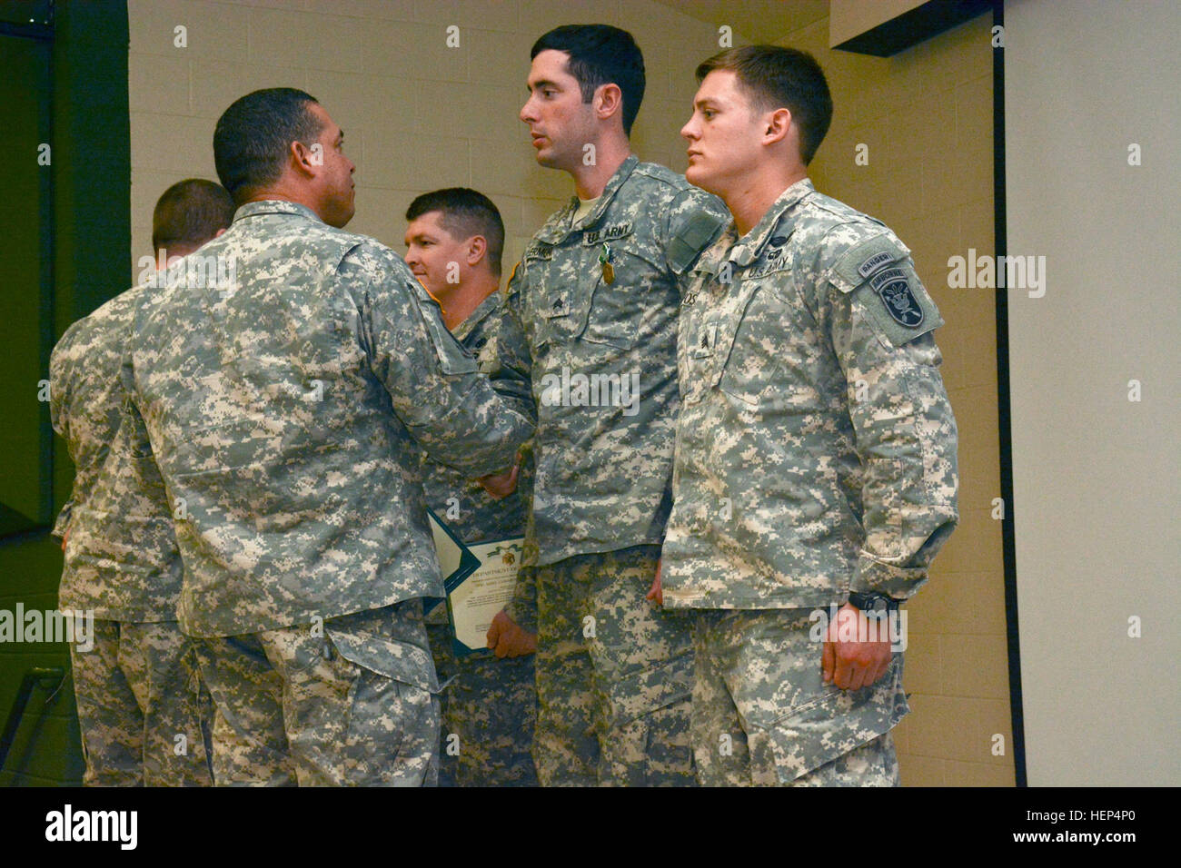 Col. Miguel A. Correa, commander of the 1st Special Warfare Training Group (Airborne), United States Army John F. Kennedy Special Warfare Center and School presents the Army Commendation Medal to Sgt. Nathan R. Foster and Sgt. Matthew A. Clermonth on February 12, at the Bank Hall Auditorium. The two Soldiers were recognized for their heroic actions, which directly resulted in saving the life of a fellow Soldier who collapsed during early morning training, November 2014. Foster and Clermon are students in the 18 Delta Special Forces Medical Sergeant Course at USAJFKSWCS. Special Forces medical  Stock Photo
