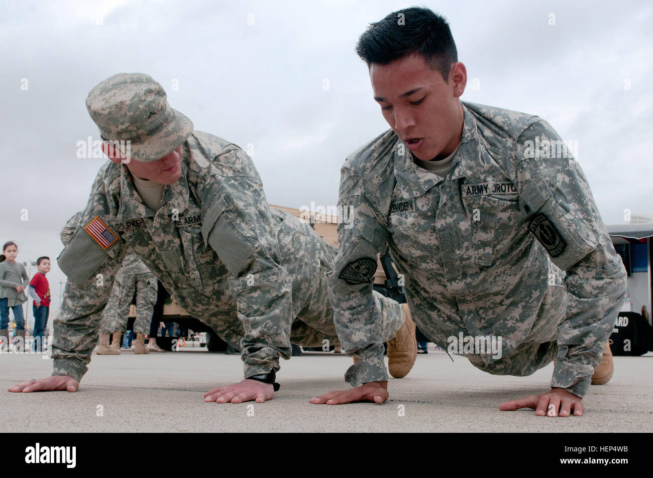 Infantryman Pvt. Javier Orouke encourages Kevin Cabrera, a student at Alexander High School in Laredo, Texas, to complete some pushups at the Texas Army National Guard recruiting display for the Laredo Air Show, Feb. 15. The Washington’s Birthday Celebration Association Stars and Stripes Spectacular Air Show is one of many events for Laredo’s month-long celebration for America’s first president. (Texas Army National Guard photo by Sgt. Michael Vanpool, 36th Infantry Division Public Affairs) Community, military team up for Laredo air show 150215-A-XD022-005 Stock Photo