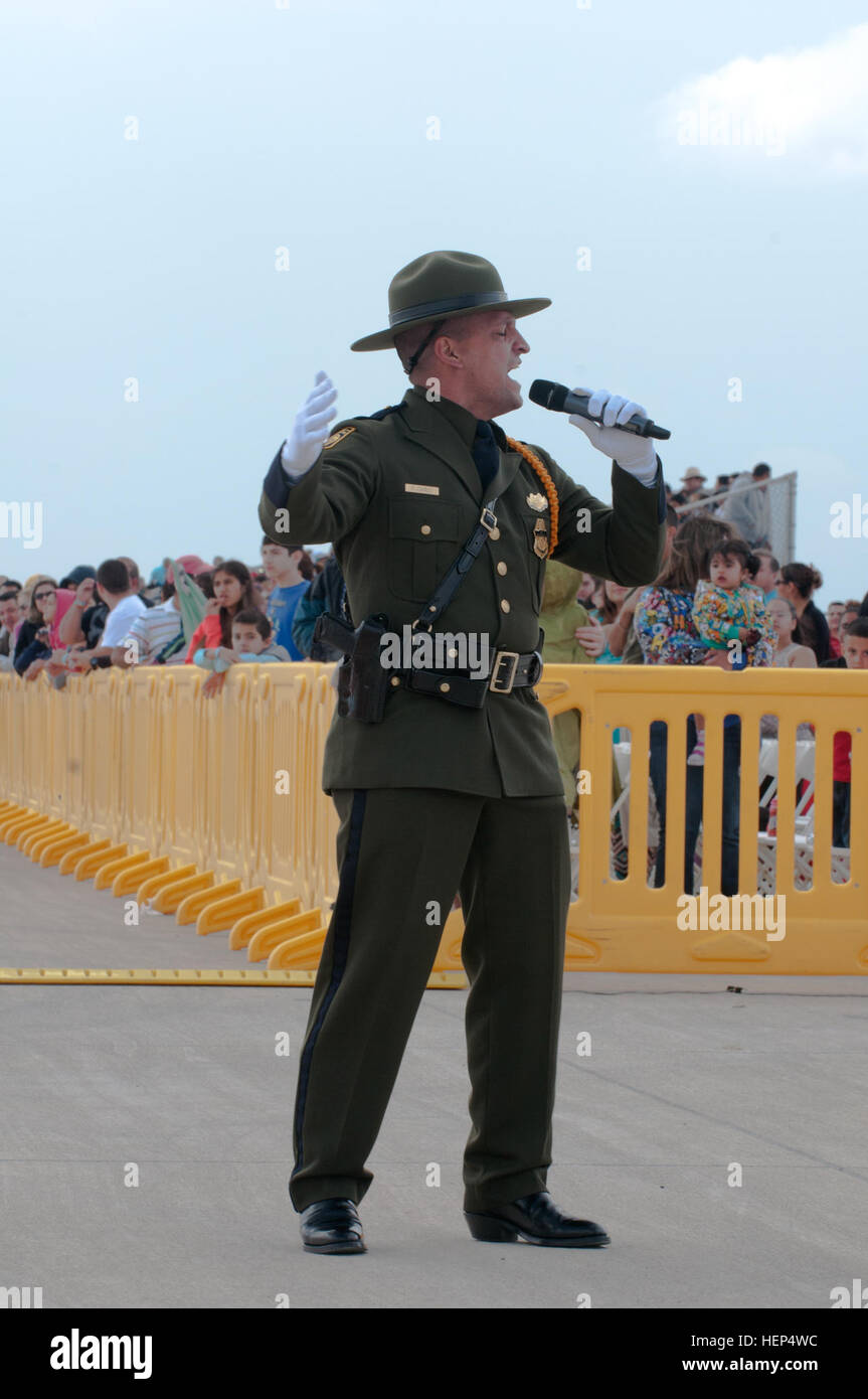 Felix Carlo, a U.S. Customs and Border Patrol Agent, sings the National Anthem to open the Stars and Stripes Spectacular Air Show in Laredo, Texas, Feb. 15. The Washington’s Birthday Celebration Association Stars and Stripes Spectacular Air Show is one of many events for Laredo’s monthlong celebration for America’s first president. (Texas Army National Guard photo by Sgt. Michael Vanpool, 36th Infantry Division Public Affairs) Community, military team up for Laredo air show 150215-A-XD022-010 Stock Photo