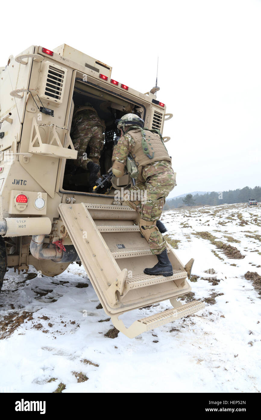 Georgian soldiers of Alpha Company, 43rd Mechanized Infantry Battalion, 4th Mechanized Infantry Brigade enter a MaxxPro Mine-Resistant Ambush Protected (MRAP) vehicle while conducting a mounted patrol during a mission rehearsal exercise (MRE) at the U.S. Army’s Joint Multinational Readiness Center (JMRC) in Hohenfels, Germany, Feb. 18, 2015. Georgian armed forces and U.S. Marine Corps Security Cooperation Group are conducting the MRE from Feb. 2 to March 3, 2015, as part of the Georgian Deployment Program-Resolute Support Mission (GDP-RSM). The GDP-RSM, formerly the Georgian Deployment Program Stock Photo