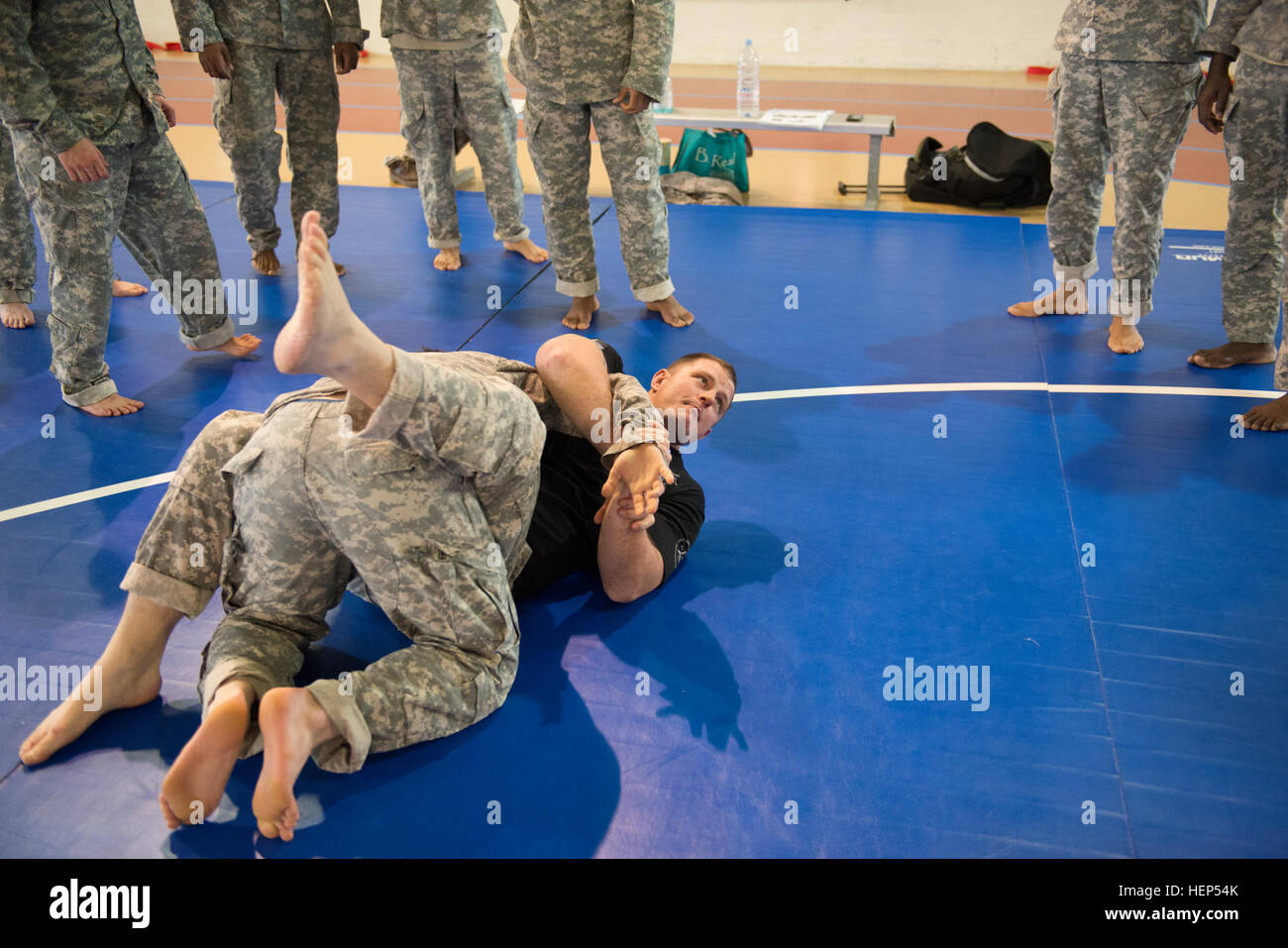 U.S. Army Sgt. 1st Class Bryan Norris, with the Headquarters, Rapid Reaction Corps-France, demonstrates how to perform a reverse bent arm bar as he teaches Tactical Combatives Course Level II to Soldiers assigned in the Supreme Headquarters Allied Powers in Europe/Chièvres community in Chièvres, Belgium, Feb. 18, 2015. (U.S. Army photo by Visual Information Specialist Pierre-Etienne Courtejoie/Released) Tactical Combatives Course Level II in Chi%%%%%%%%C3%%%%%%%%A8vres, Belgium 150218-A-BD610-136 Stock Photo