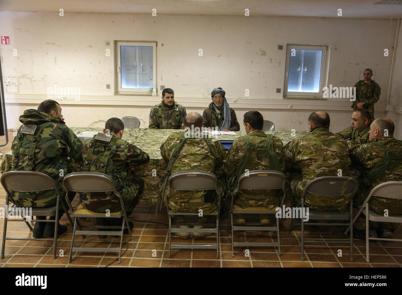 Georgian and Moldovan soldiers conduct a key leader engagement with a ...