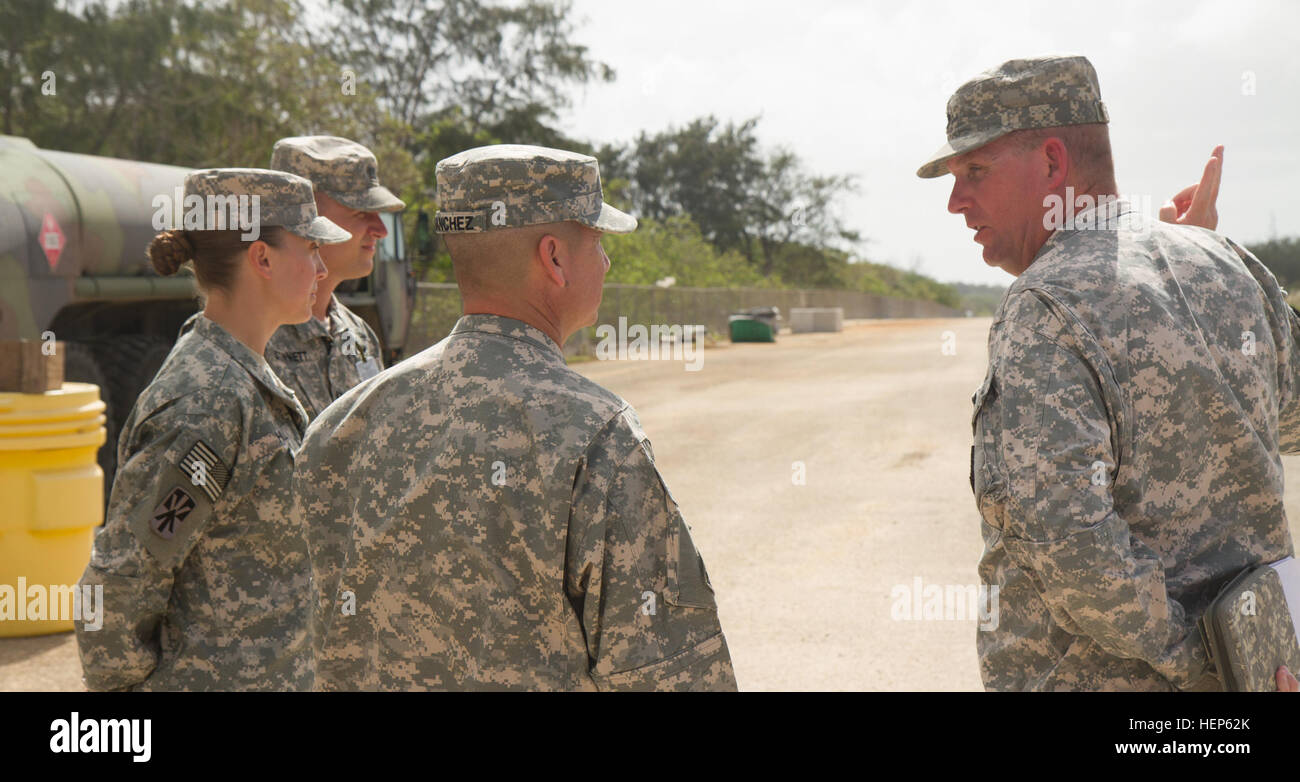 U.S. Army Lt. Col. Clyde Cochrane III, (far right) the commander of Task Force Talon, 94th Army Air and Missile Defense Command, and Capt. Candace Hill, (left) commander of Battery D, 2nd Air Defense Artillery Regiment, Task Force Talon, discusses with Brig. Gen. Eric L. Sanchez, (center) the commander of the 94th AAMDC, March 3, 2015, some of changes that have been made to the Task Force Talon Armadillo site at Andersen Air Force Base, Guam. Hill is the first female officer to command a forward deployed Terminal High Altitude Area Defense battery. (U.S. Army photo by Sgt. Kimberly K. Menzies, Stock Photo