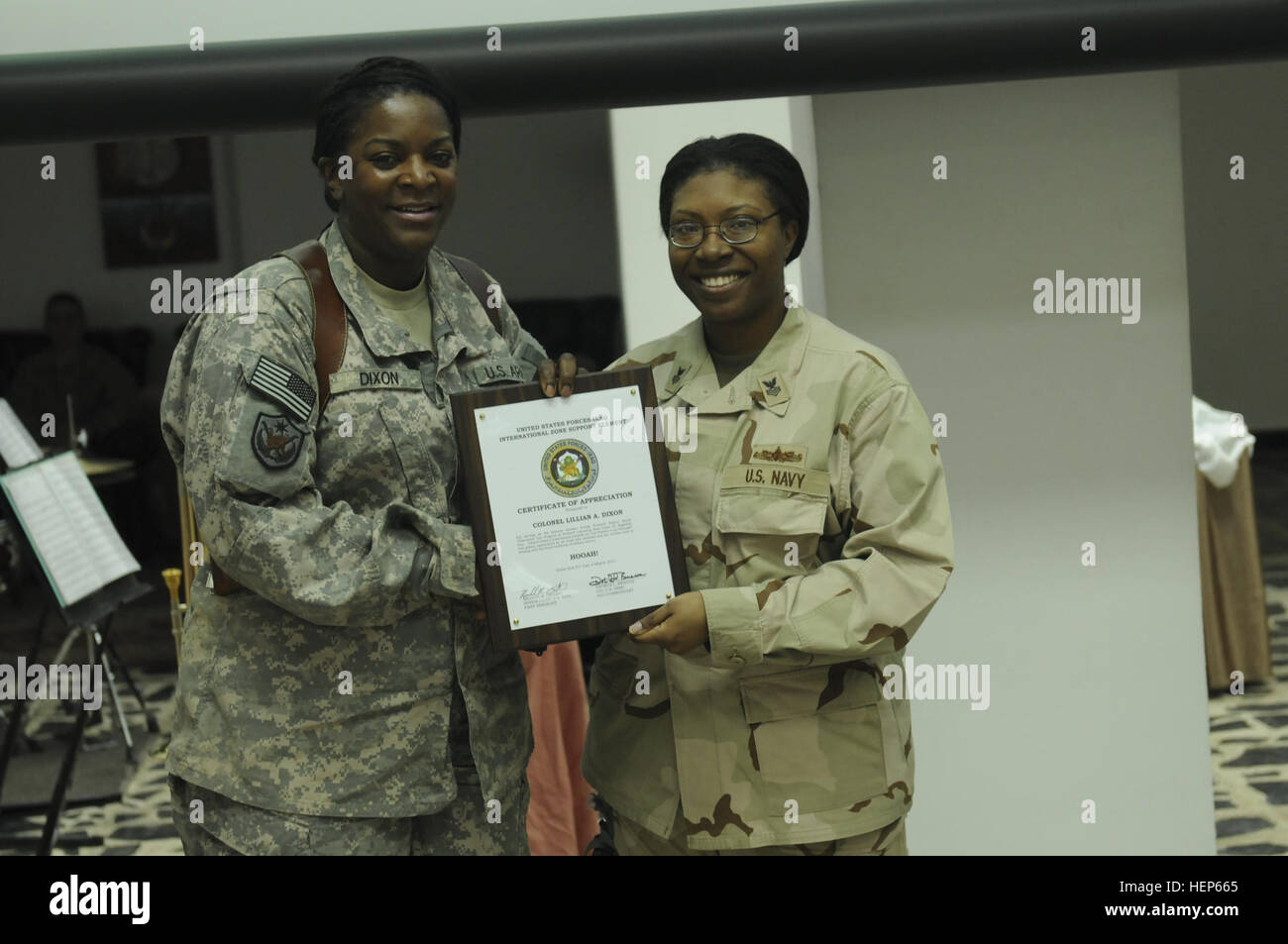 U.S. Navy Petty Officer 1st Class Fredrica Johnson, Forward Operating Base Union III’s Equal Opportunity Committee leader, presents U.S. Army Col. Lillian Dixon, keynote speaker for the Women's History Month luncheon, with a certificate of appreciation during the observance at the Babylon Conference Center here March 31. Dixon was the first female to serve as the Fort Jackson, S.C., garrison commander; a position she filled from 2007 to 2010. US, ISF women serve as living examples for Women%%%%%%%%E2%%%%%%%%80%%%%%%%%99s History 385211 Stock Photo