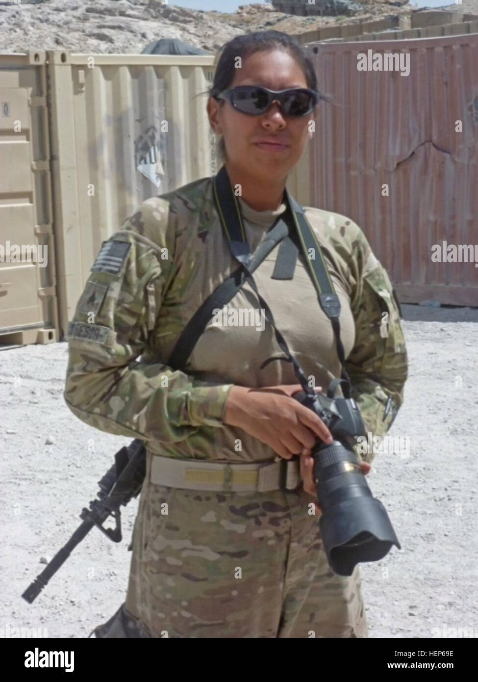 Staff Sgt. Nazly Confesor is a public affairs journalist for the 200th Military Police Command, now living in Washington with a deployment to southern Afghanistan in 2011-2012 to cover stories of Soldiers in combat. This photo of her was taken at Forward Operating Base Masum Ghar in October, 2011. She is one of the women interviewed to give a woman's perspective of what it's like to serve in the Army as a female Soldier. (Courtesy photo) Stepping into Women's combat boots 111001-A-XX000-001 Stock Photo