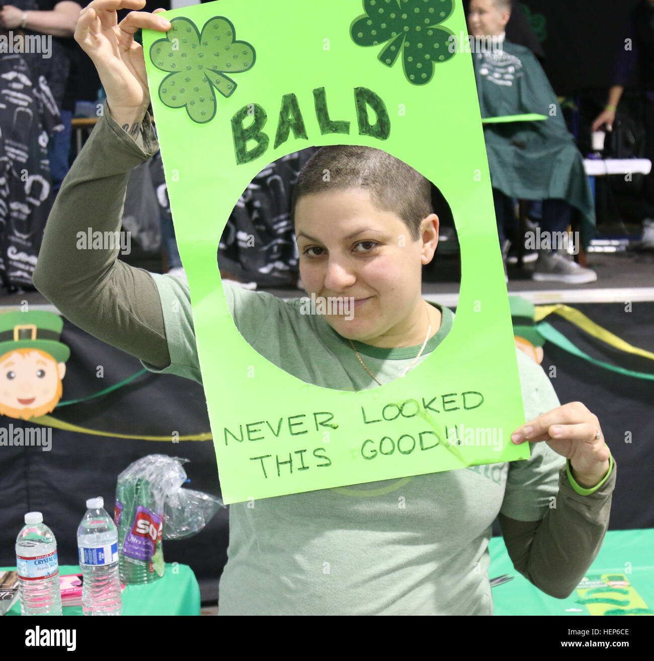 Sgt. 1st Class Madeline Diaz, 62nd Medical Brigade, 593rd Expeditionary Sustainment Command, poses after receiving a haircut at a Shave a Servicemember Charity Event March 7, 2015, at Joint Base Lewis-McChord, Wash. The event was a fundraiser in support of the St. Baldrick’s Foundation and their children’s cancer research. Soldier shaves head in support of cancer research 150307-A-GY358-002 Stock Photo