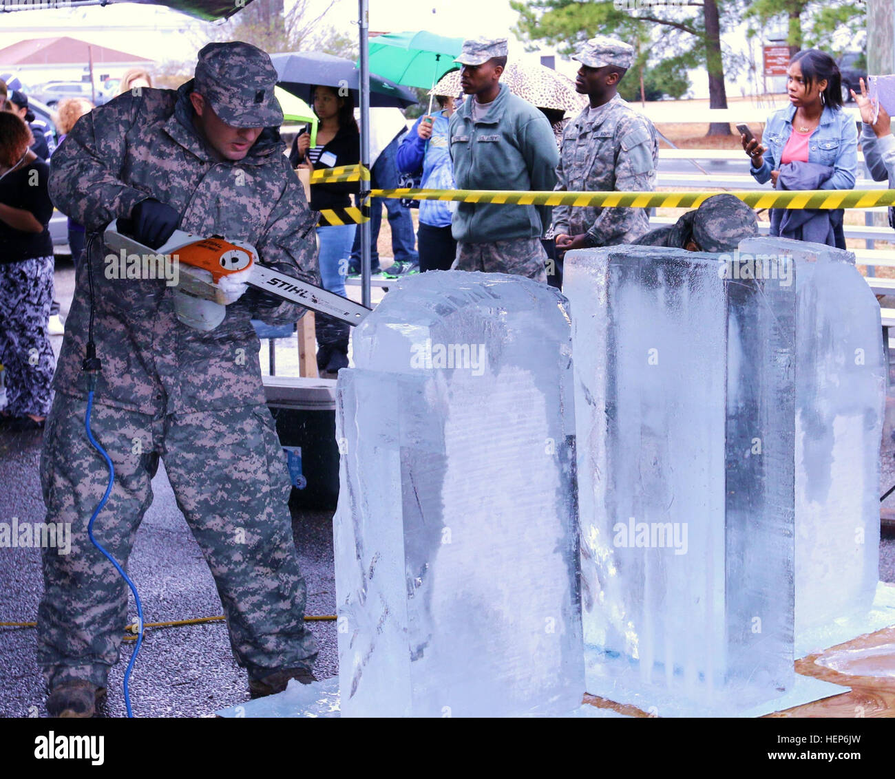 Staff Sgt. Markos Mendoza, a cook assigned to the 257th Transportation Company, cuts into a block of ice with a chainsaw during the ice sculpting competition at the 40th Annual Military Culinary Arts Competitive Training Event held at Fort Lee, Va., March 11. Mendoza and his teammate Spc. Nathanael Dewey, a cook assigned to the 103rd Sustainment Command (Expeditionary), represented the Army Reserve in the ice sculpting competition, and although neither Soldier had ice carving experience they managed to earn a bronze medal for their carving of the characters from the 'Minions,' a popular 3-D co Stock Photo