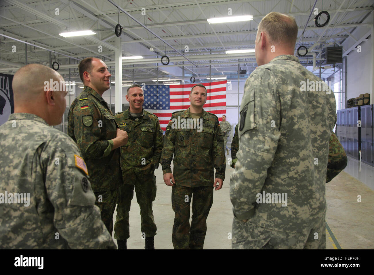 U.S. Army soldiers from the 982nd Combat Camera Company speak with German soldiers from the 26th Abu Brigade and Lufflandebrigade 26 at Dobbins Air Reserve Base, Ga., March 16, 2015. Operation Skyfall is a joint, multilateral combat camera subject matter expert exchange, hosted by the 982nd Combat Camera Company, which takes place at multiple locations in Georgia. Operation Skyfall is an event which focuses on interoperability of combat camera training and capturing airborne operations with three partner nations and multi-service units. (U.S. Army photo by Spc. Kelson Brooks / Released) Operat Stock Photo