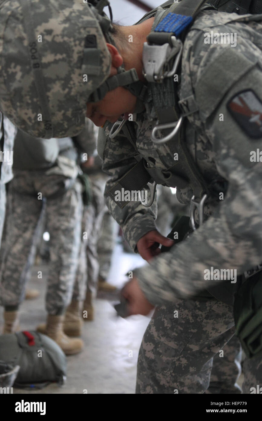 U.S. Army paratrooper Spc. Lisa Soy, assigned to 55th Signal Company (Combat Camera), prepares her parachute for Operation Skyfall at Silver Comet Field at Paulding Northwest Atlanta Airport March 17, 2015. Operation Skyfall is a joint multi-lateral combat camera airborne subject matter expert exchange, hosted by 982nd Combat Camera Company, which takes place at multiple locations in Georgia. Operation Skyfall is an event which focuses on interoperability of combat camera training and capturing airborne operations with three partner nations and multi-service units. (U.S. Army Photo by Pfc. Jes Stock Photo