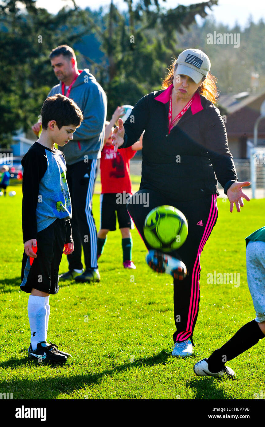 Kathleen Powell A Volunteer Coach For Youth Soccer Demonstrates A Different Way To Practice A Ball Control Drill To One Of Her Players During A Practice At Joint Base Lewis Mcchord Wash March