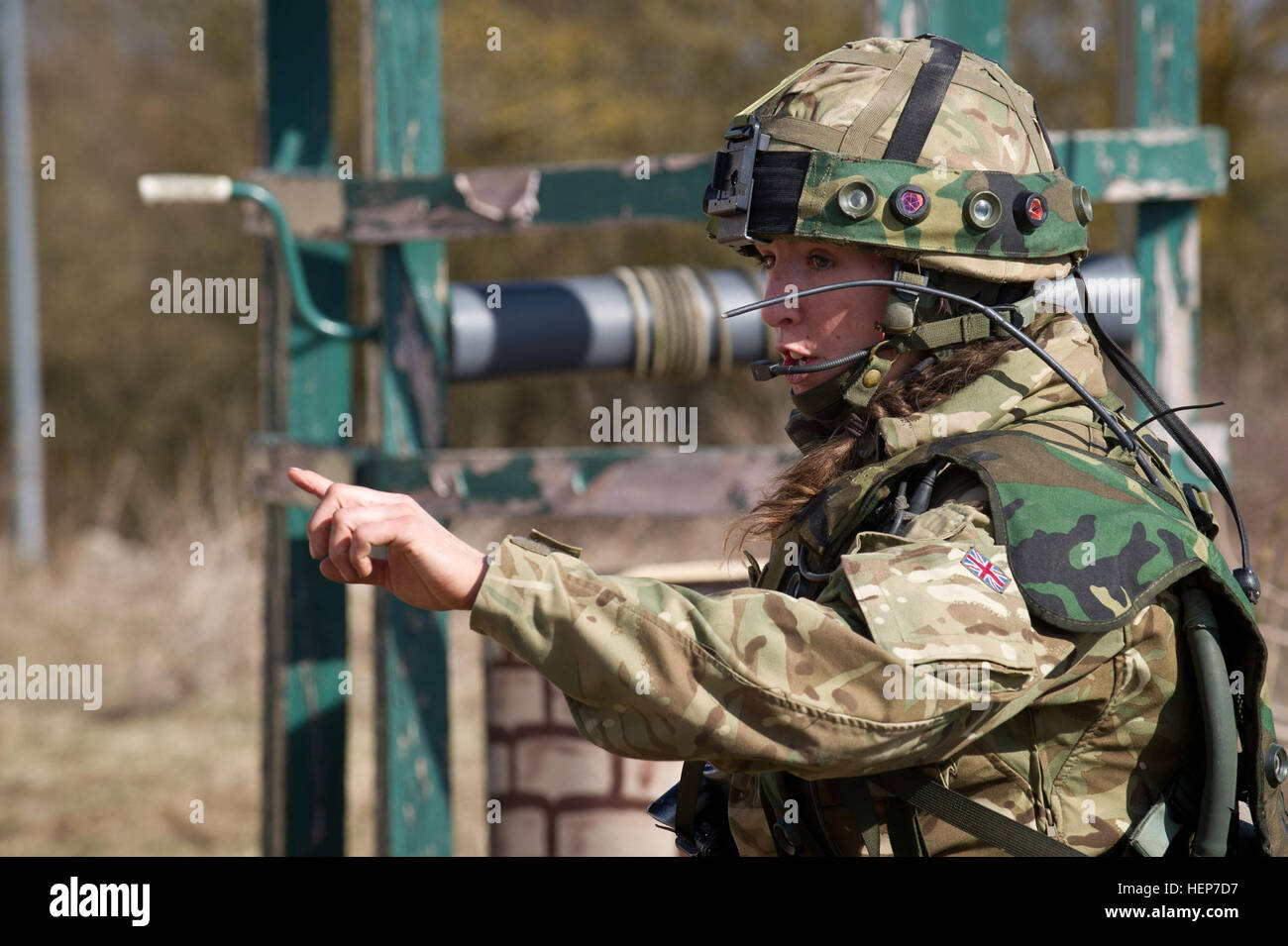 A British cadet of the Royal Military Academy Sandhurst gives orders to her fellow cadets during final evaluation and validation training at the Joint Multinational Readiness Center in Hohenfels, Germany, March 18, 2015. The intent of the certification exercise is to train and evaluate cadets on decision-making, planning, field craft expertise, and operations in a tactical environment in order to prepare officer cadets for commissioning into the British Army. (U.S. Army photo by Sgt. 1st Class Caleb Barrieau) Royal Military trains at JMRC 150318-A-WB953-532 Stock Photo