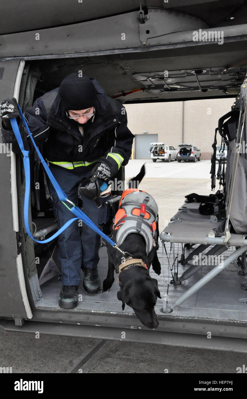 Jax, a K9 search and rescue dog, and his handler, Brian White, receive