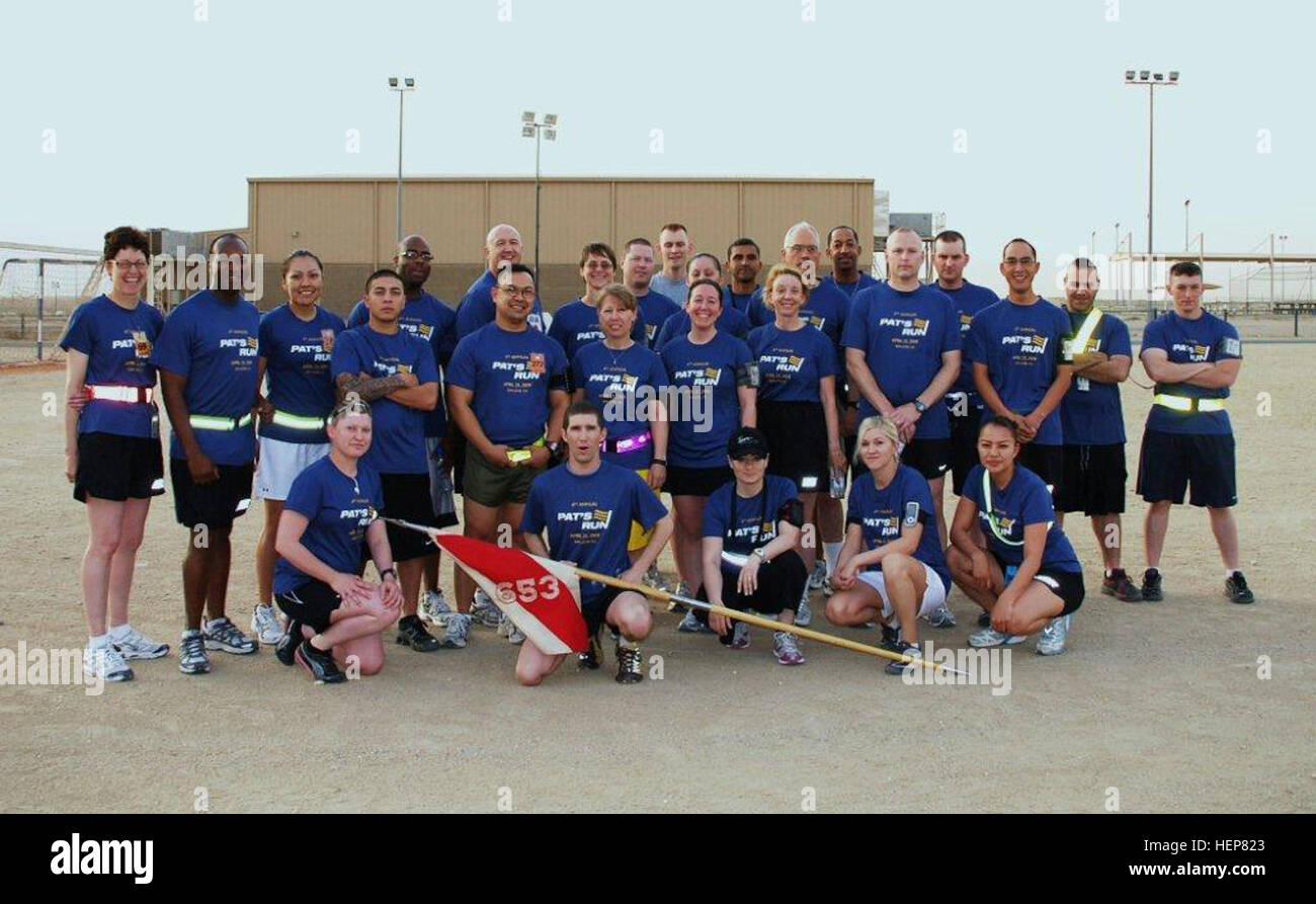 Members from the 653rd Regional Support Group from Mesa, Ariz., pose for a group photo before starting the Army Reserve's Birthday Run/Walk, April 24, at the Zone 1 soccer field, Camp Arifjan, Kuwait. While the group was running in celebration of the Army Reserve's 102nd birthday, they were also running to celebrate the life and service of Pat Tillman, a former Arizona State University football player who was killed in action while serving with the 75th Ranger Regiment in Afghanistan. It is known as 'Pat's Run' and is a fundraiser held by the Pat Tillman Foundation in celebration of the life a Stock Photo