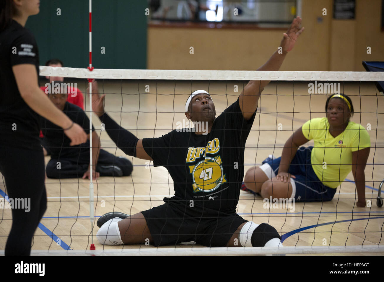 U.S. Army Veteran Alexander Shaw, Clarksville, Tennessee, hits the ball over the net during sitting volleyball practice for the 2015 Army Trials at Soto Physical Fitness Center on Fort Bliss, Texas, March 27, 2015. Approximately 80 wounded, ill, and injured Soldiers and Veterans are at Fort Bliss to train and compete in a series of competitive athletic events including archery, cycling, shooting, sitting volleyball, swimming, track and field and wheelchair basketball. Army Trials, March 29-April 2, is conducted by the Army Warrior Transition Command and hosted by Fort Bliss. Army Trials help d Stock Photo