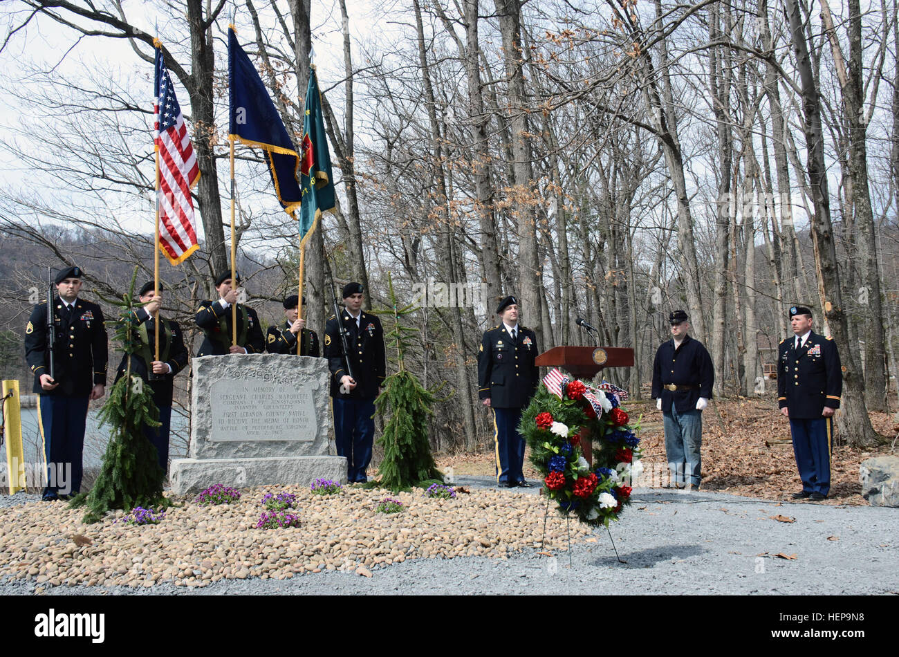 Attendees at a wreath-laying ceremony commemorating the 150th anniversary of the event that led to Lebanon County's Sgt. Charles Marquette receiving the Medal of Honor stand following the conclusion of taps at the installation's Marquette Lake, April 2, 2015. Marquette belonged to what was the 93rd Pennsylvania Volunteer Infantry Regiment and impaled himself while placing the nation's flag on enemy fortifications during the siege of Petersburg, April 2, 1865, and was awarded the Medal of Honor, May 10, 1865. (U.S. Air National Guard photo by Tech. Sgt. Ted Nichols/Released) Medal of Honor reci Stock Photo