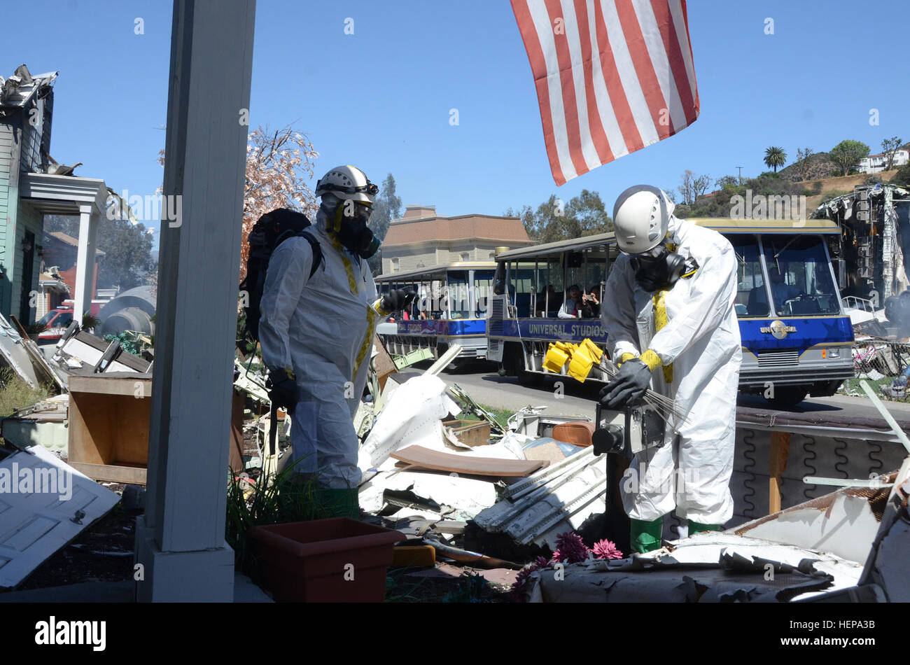 Members of the California National Guard's Los Alamitos-based 9th Civil Support Team survey the wreckage of a simulated plane crash at Universal Studios Hollywood April 8. The survey team found dangerous radiation levels at the site, where a health care company had used radioactive isotopes to make products used in medical tests. 9th CST brings expertise, sense of purpose to disaster response, Universal Studios lends realistic setting to jet crash, radiation leak drill 150408-A-BH123-002 Stock Photo