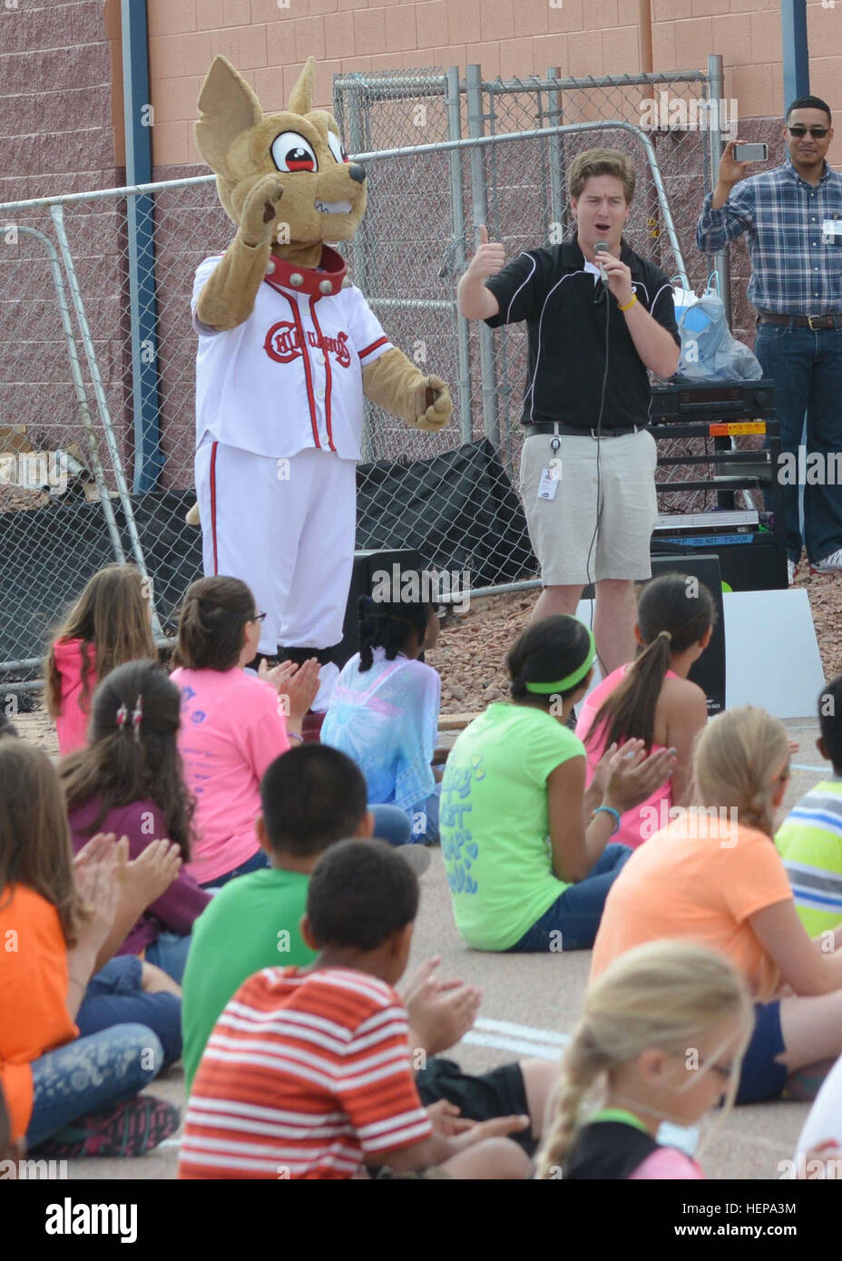 Chico the Chihuahua, the mascot for the El Paso Chihuahua baseball team, attends an assembly at Milam Elementary School, April 8, to show his appreciation for the school’s support of the Braden Aboud Foundation. The foundation holds a walk/run annually, earning money to donate shoes to local elementary schools. Braden Aboud Foundation donates shoes to Milam Elementary 150408-A-IX573-020 Stock Photo