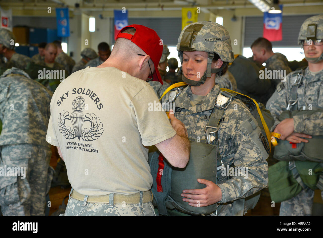A U.S. Army parachute rigger (left) assigned to the 173rd Airborne
