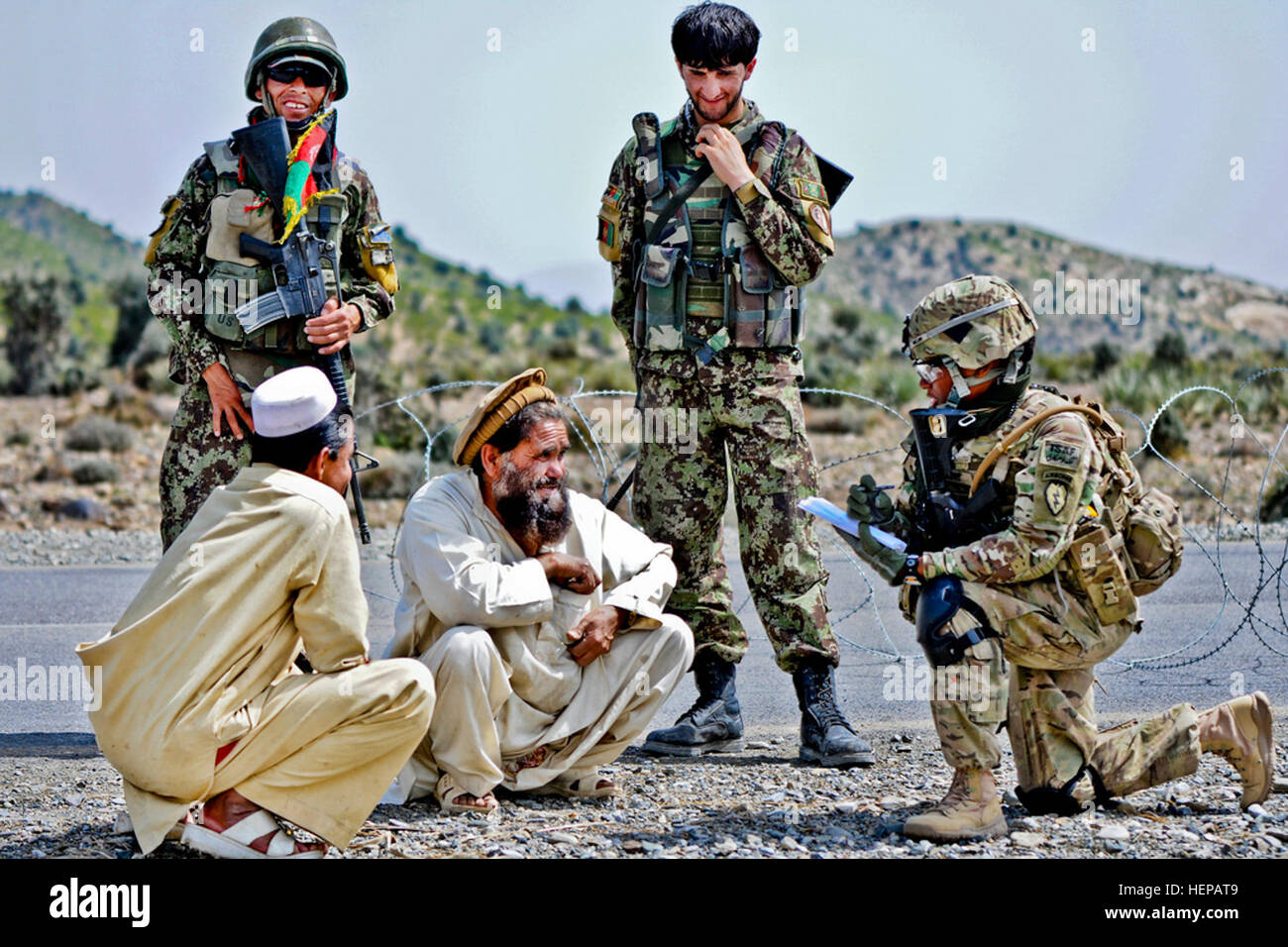 U.S. Army Sgt. Shawnte Rollins (right), a field artillery surveyor