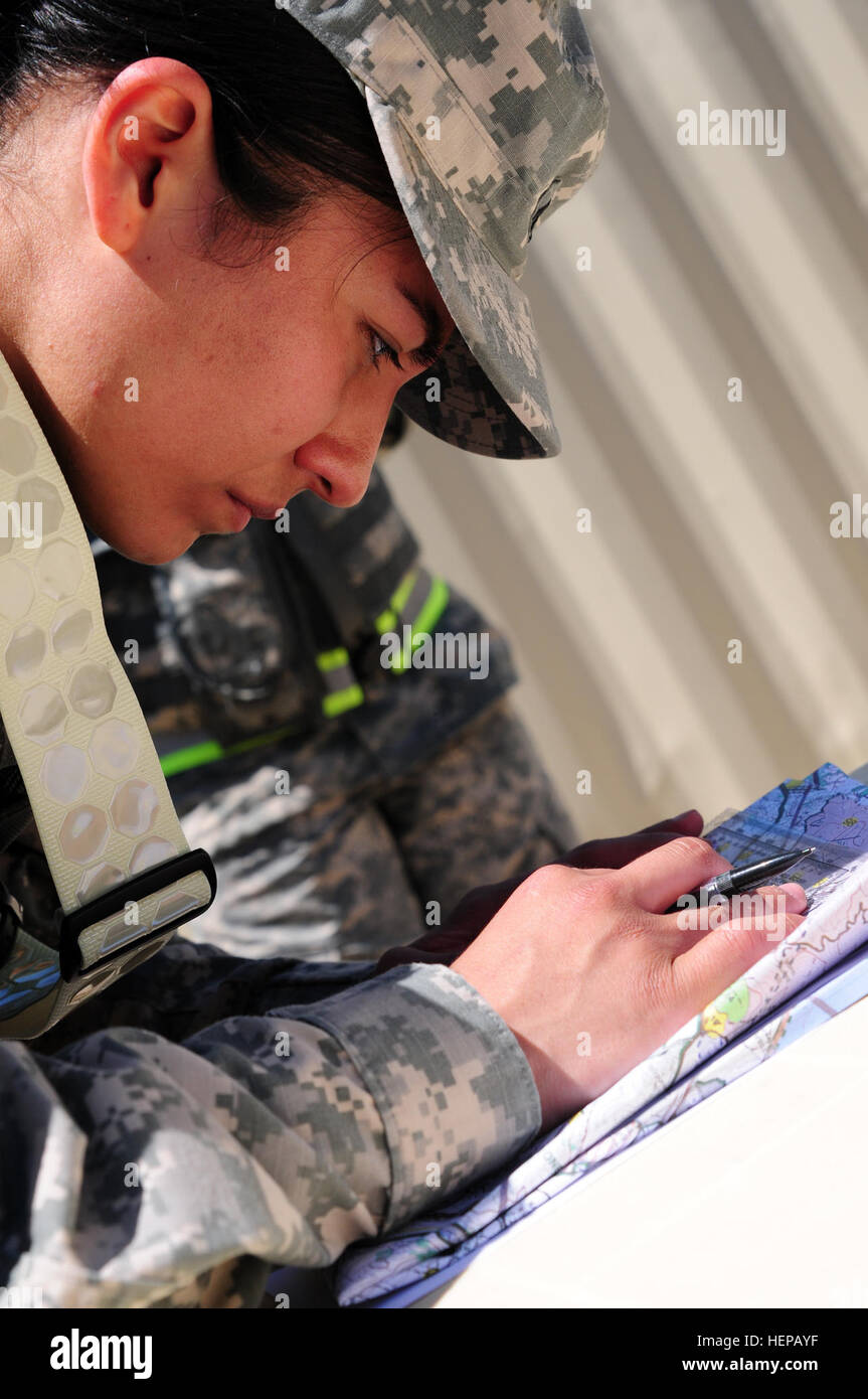 Sgt. Yessenia Silva, a water purification specialist with the 961st Quartermaster Company, 4th Expeditionary Sustainment Command, plots points on a map during the Land Navigation Course portion of the Best Warrior Competition hosted by the 79th Sustainment Support Command at Camp Pendleton, Calif., April 18, 2015. The Best Warrior Competition seeks out the best candidate that defines a U.S. Army Soldier by testing Soldiers physically and mentally. The competition will consist of one enlisted Soldier and one noncommissioned officer from four separate one-star commands, which fall underneath the Stock Photo
