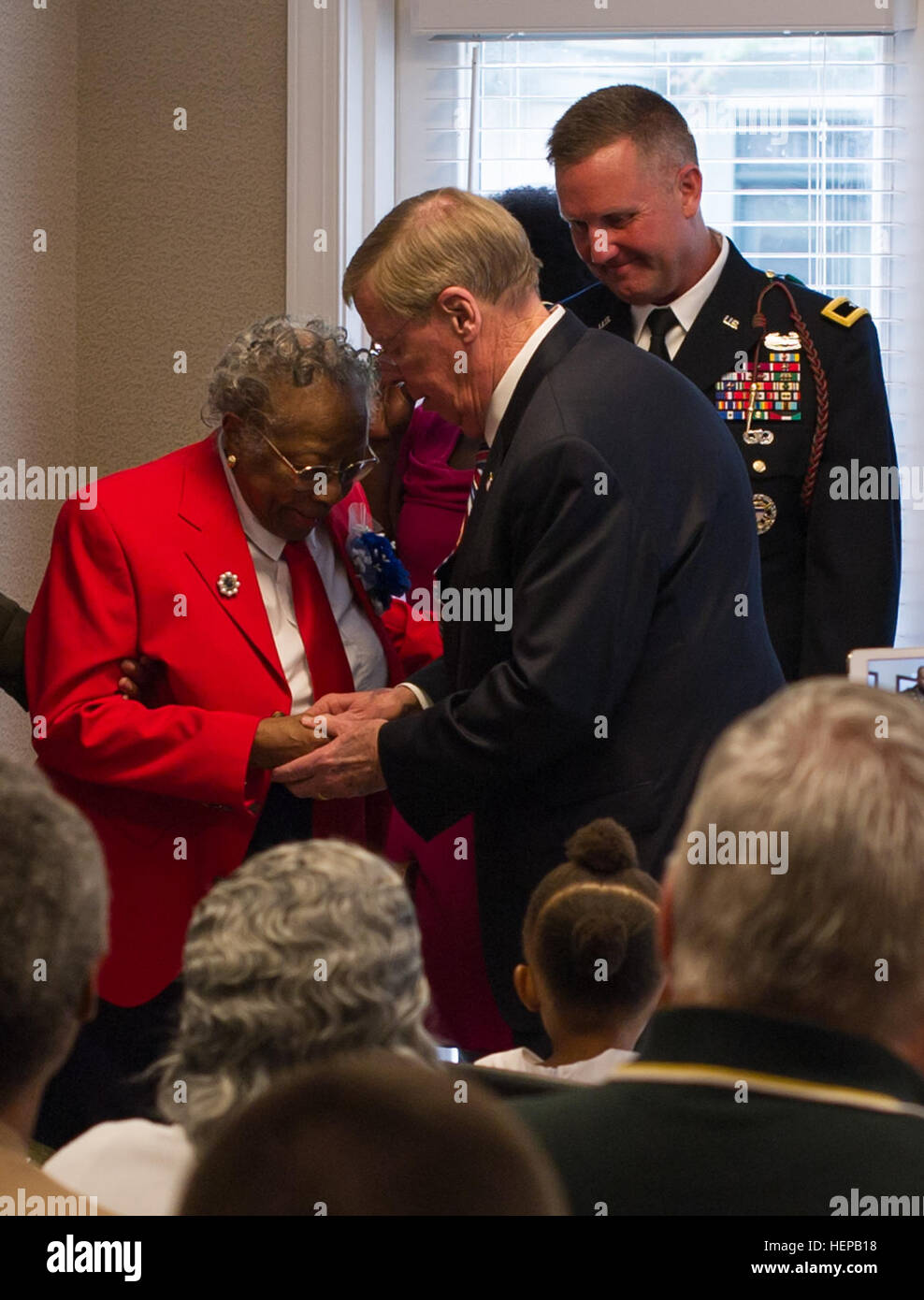 U.S. Sen. Johnny Isakson, R-Ga, along with Brig. Gen. James Blackburn and Command Sgt. Maj. Stanley Varner, command team for Task Force Marne, 3rd Infantry Division, presents a bronze replica of the Congressional Gold Medal to Sgt. Amelia Jones, a veteran of the original Tuskegee Airman, at Hospice Savannah, April 19. All in attendance gathered to witness the 95-year-old veteran receive the bronze replica. The Actual Congressional Gold Medal is one of the two highest civilian awards in the United States. The medal was awarded to the Tuskegee Airmen as a group in 2007. Before 1940, African Amer Stock Photo