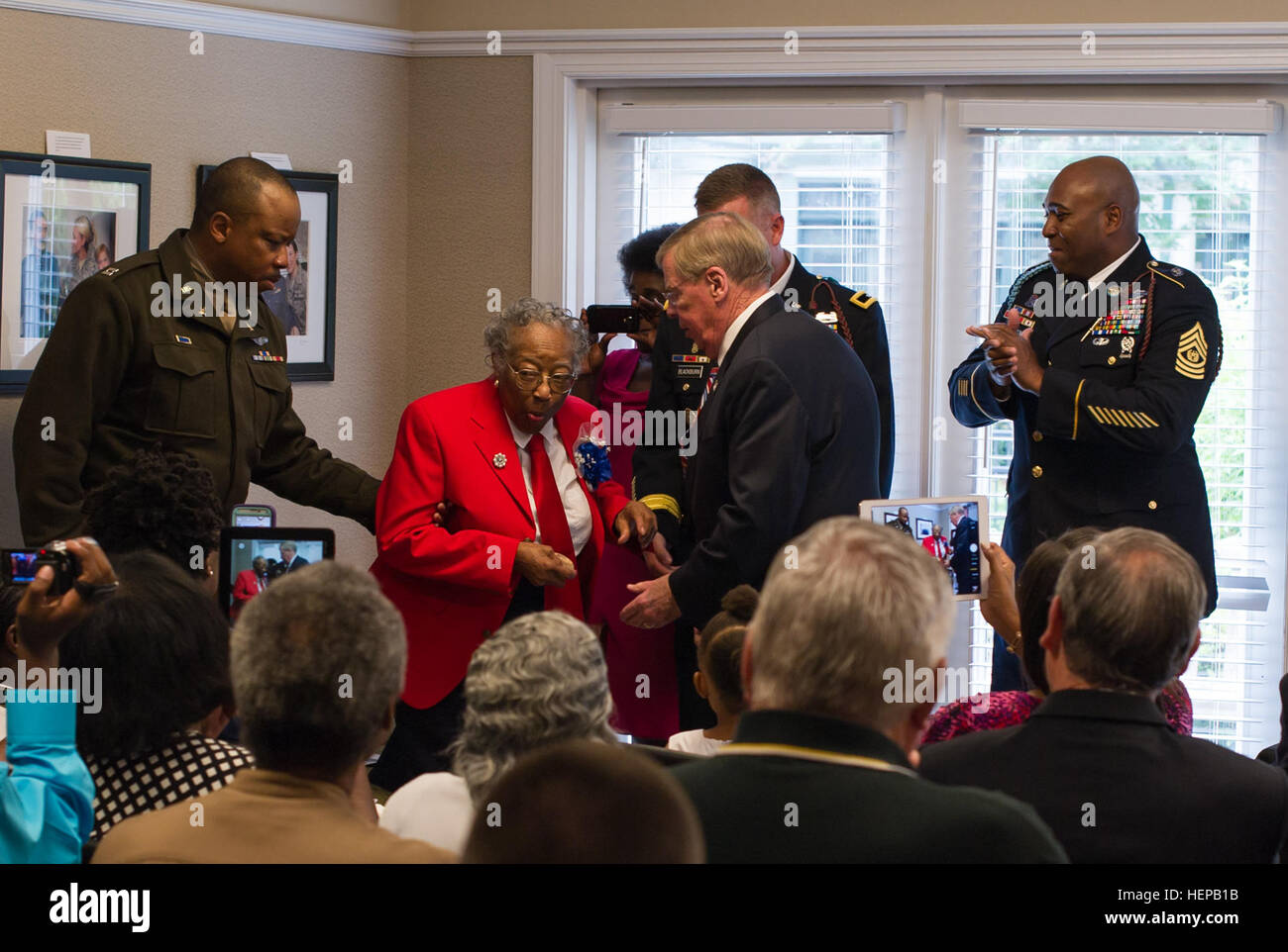 Sgt. Amelia Jones, a veteran of the original Tuskegee Airman, gets excited after receiving a bronze replica of the Congressional Gold Medal at Hospice Savannah, April 19. All in attendance gathered to witness the 95-year-old veteran receive the replica. The Actual Congressional Gold Medal is one of the two highest civilian awards in the United States. The replica was presented to her by U.S. Sen. Johnny Isakson, R-Ga., along with Brig. Gen. James Blackburn and Command Sgt. Maj. Stanley Varner, command team for Task Force Marne, 3rd Infantry Division. The Congressional Gold Medal was awarded to Stock Photo