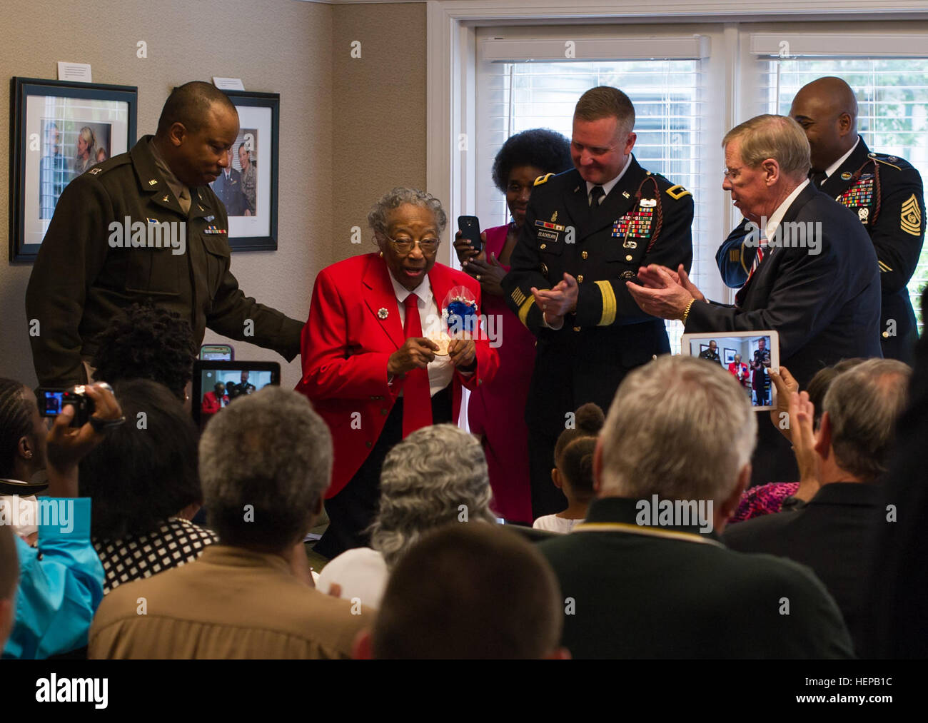 Sgt. Amelia Jones, a veteran of the original Tuskegee Airman, addresses those in attendance, after receiving a bronze replica of the Congressional Gold Medal at Hospice Savannah, April 19. All in attendance gathered to witness the 95-year-old veteran receive the replica. The actual Congressional Gold Medal is one of the two highest civilian awards in the United States. The replica was presented to her by U.S. Sen. Johnny Isakson, R-Ga., along with Brig. Gen. James Blackburn and Command Sgt. Maj. Stanley Varner, command team for Task Force Marne, 3rd Infantry Division. The Congressional Gold Me Stock Photo