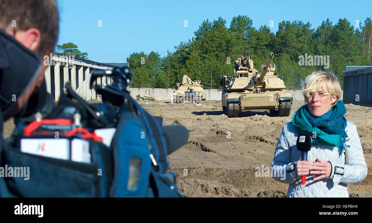 Soldiers from 2nd Battalion, 7th Infantry Regiment, 3rd Infantry Division out of Fort Stewart, Ga., maneuver a M1A2 Abrams Battle Tank as part of a media engagement with for Swedish News Agency YLE during Operation Atlantic Resolve, held in Adazi, Latvia, April 23. (Photo by U.S. Army Staff Sgt. Brooks Fletcher, 16th Mobile Public Affairs Detachment) 2-7 Infantry Media Engagement 150423-A-JK968-001 Stock Photo