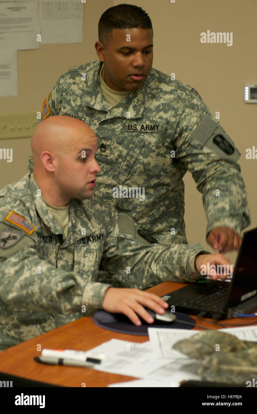 Sgt. 1st Class David Hernandez, a combat medic with the 176th Medical Battalion, 807th Medical Command (Deployment Support) instructs Sgt. Daniel Divincenzo on proper incident reporting procedures during Vibrant Response 2015 located at Camp Atterbury, Ind. This training exercise brings service members, and civilians from multiple federal and state agencies together to practice catastrophic domestic incident response. (US Army photo by Capt. Chad Nixon) Vibrant Response 2015 150423-A-ZZ999-001 Stock Photo