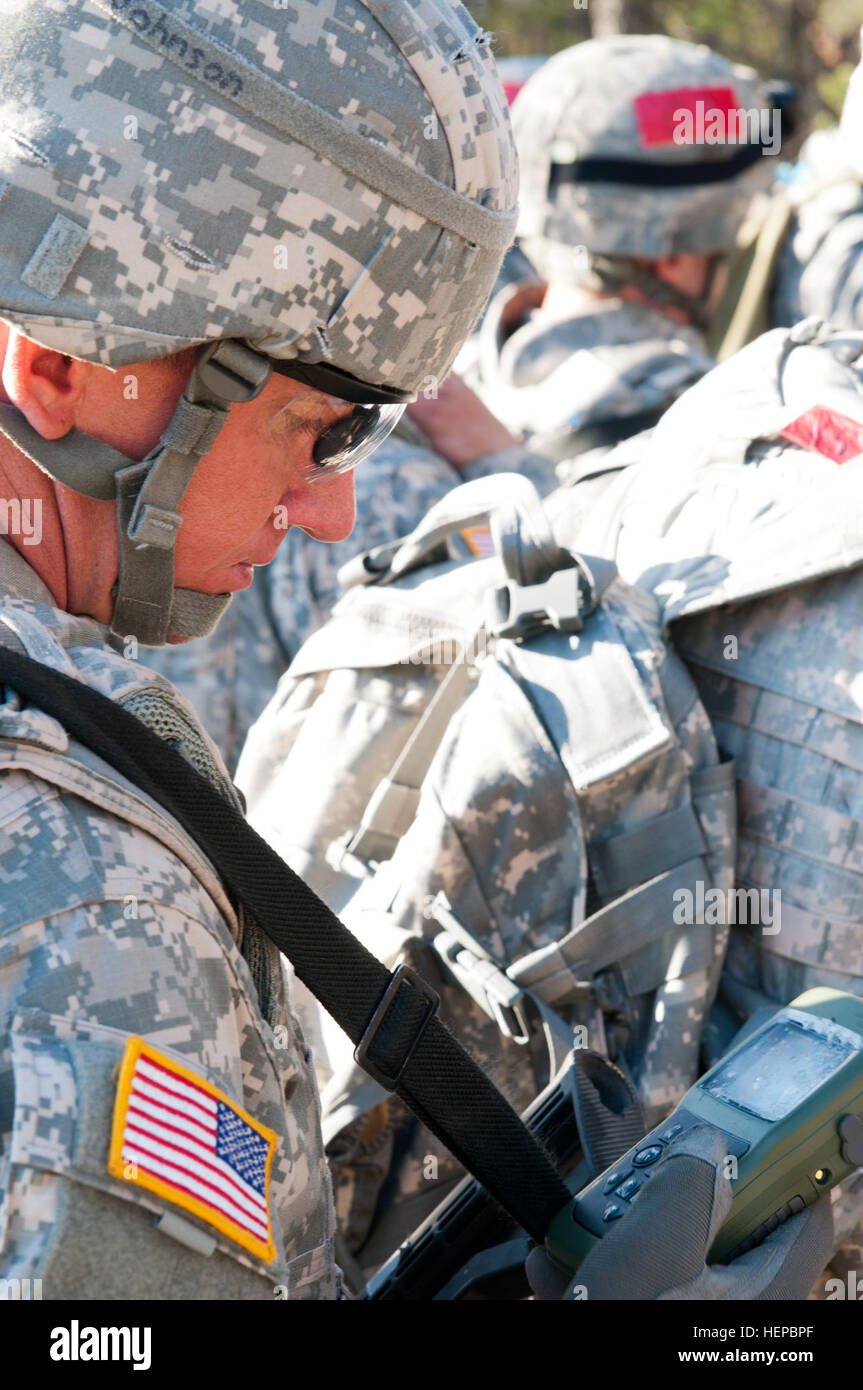 Best Warrior competitor Pfc. Derek Johnson, 412th Theater Engineer Command Soldier, from Pleasant Garden, N.C., function checks his Defense Advanced GPS Receiver (DAGR), the military's satellite positioning system, before doing the day and night land navigation course portion of the 2015 Combined TECs' Best Warrior Competition. The 36 U.S. Army Reserve Soldiers from the 412th and 416th TECs met at Fort McCoy, Wis., April 25 to 29 to represent their command in the competition. One noncommissioned officer and one junior enlisted Soldier from each command will compete at the next level: the U.S.  Stock Photo