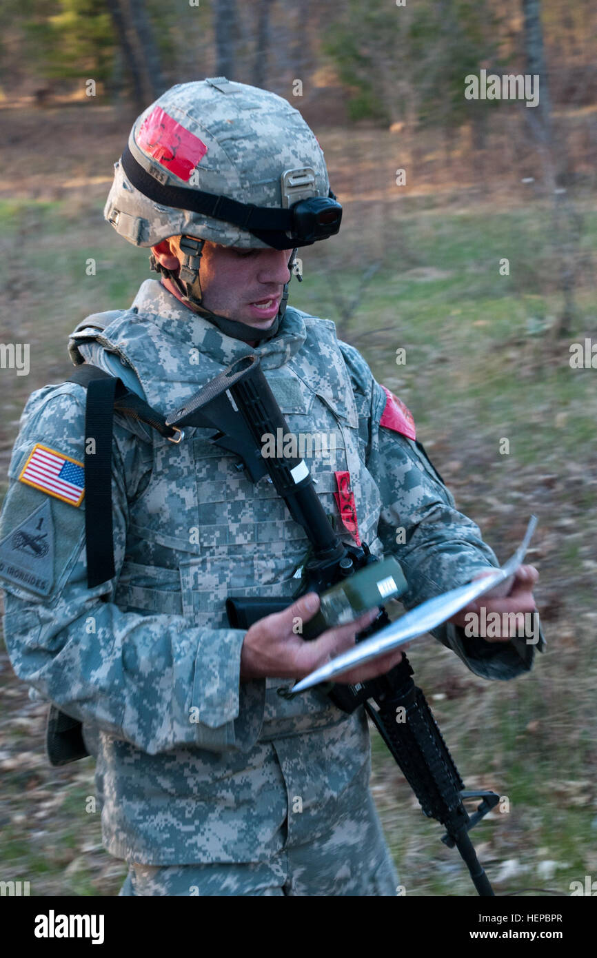 Sgt. Albert Barnes, a 412th Theater Engineer Command Soldier from Meriden, Conn., tracks points over the 5 km course of rough terrain, using only a Defense Advanced GPS Receiver (DAGR), the military's satellite positioning system, a map, compass, protractor, dead reckoning and terrain association as part of the day and night land navigation course portion of the 2015 Combined TEC Best Warrior Competition. The 36 U.S. Army Reserve Soldiers from the 412th and 416th TECs met at Fort McCoy, Wis., April 25 to 29 to represent their command in the competition. One noncommissioned officer and one juni Stock Photo