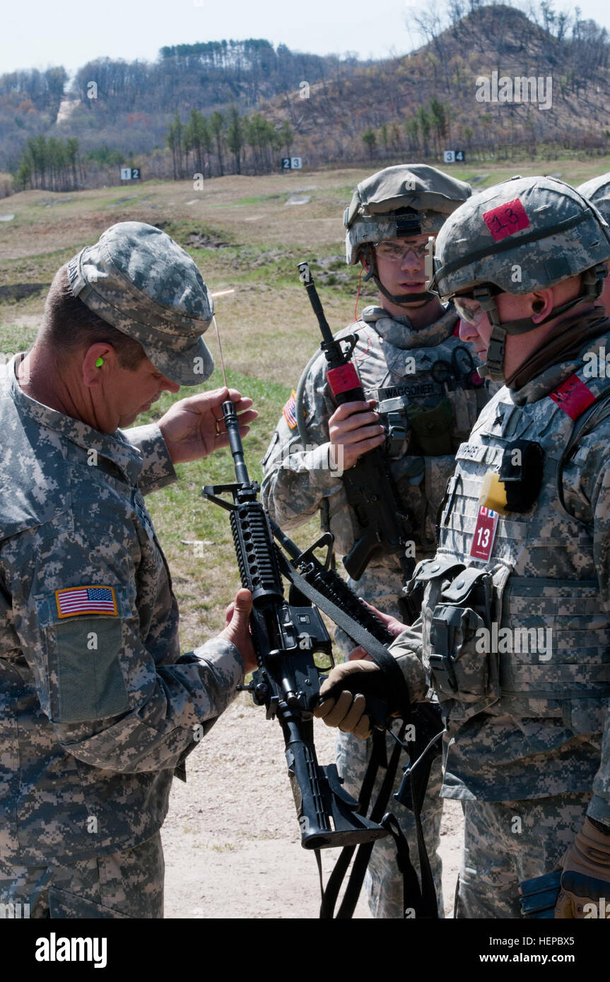 A Best Warrior safety cadre clears an M4 rifle after firing during the ...