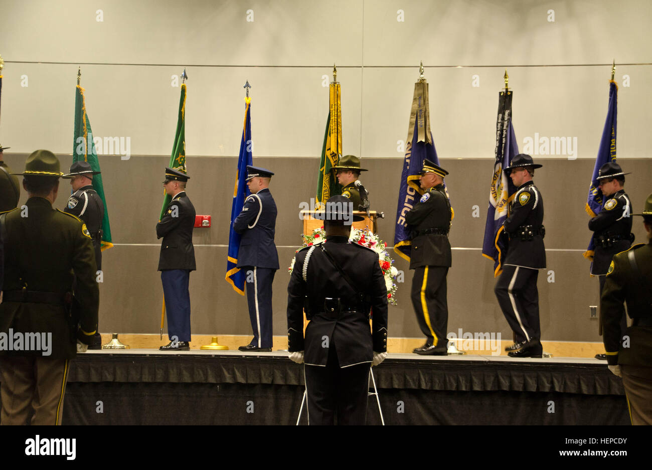 The Honor Guard from multiple law enforcement agencies collect their respective guidons at the Pierce County Law Enforcement Memorial at Clover Park Technical College in Lakeview, Wash., May 5. The purpose of the memorial is to honor the men and women police officers who have lost their lives in the line of duty.  (U.S. Army photos by Sgt. Jasmine Higgins, 28th Public Affairs Detachment) Guard 150505-A-HS859-361 Stock Photo