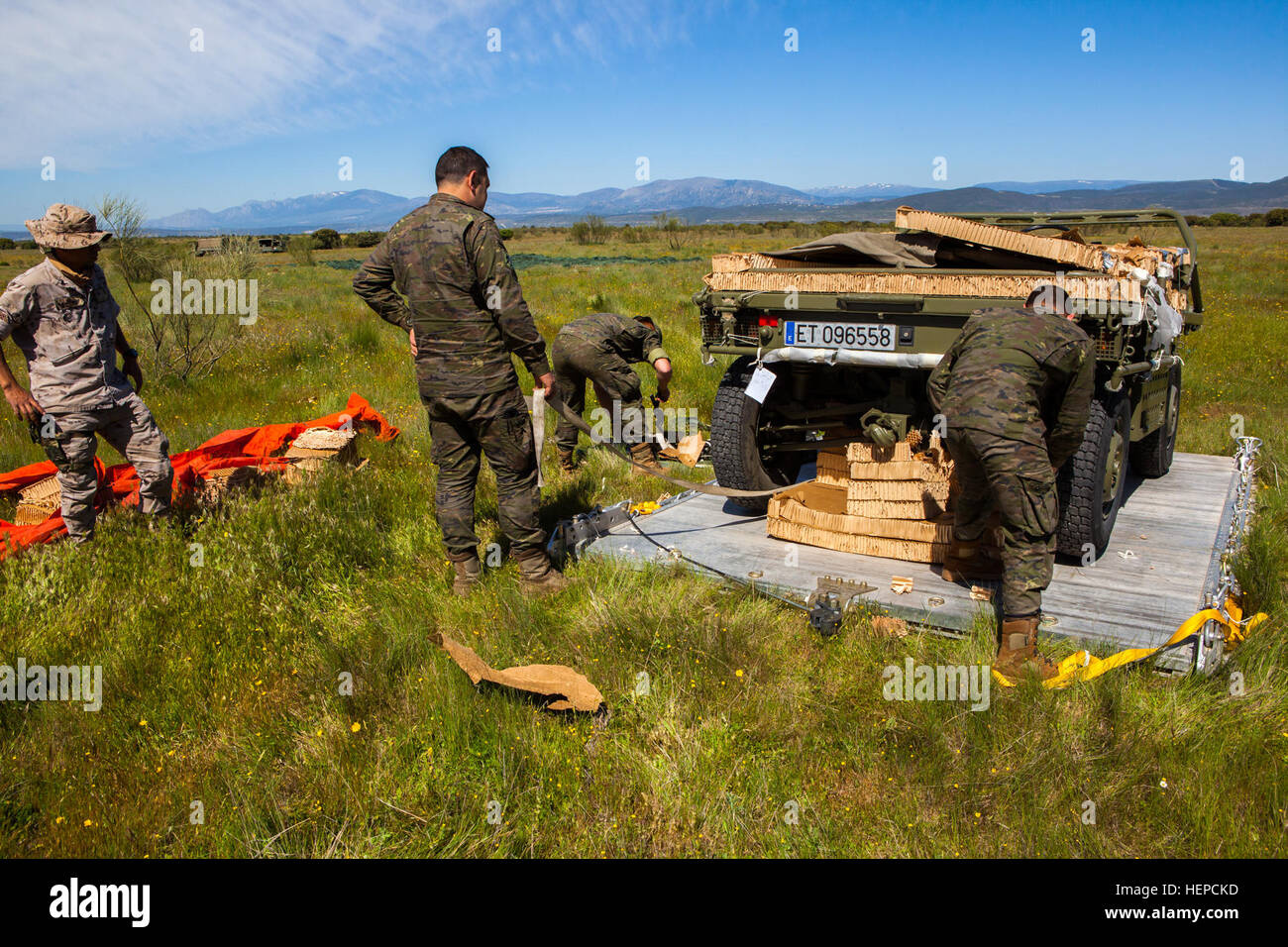 Spanish Soldiers from the Brigada Paracaidista recover a transport vehicle following an airborne cargo drop during Operation Skyfall - España, Madrid, Spain, May 7, 2015. Operation Skyfall - España is an exercise initiated and organized by the 982nd Combat Camera Company, and hosted by the Brigada Paracaidista of the Spanish army. The exercise is a bilateral subject matter exchange focusing on interoperability of combat camera training and documentation of airborne operations. (U.S. Army photo by Staff Sgt. Justin P. Morelli / Released) Operation Skyfall - Espa%%%%%%%%C3%%%%%%%%B1a 150507-A-PP Stock Photo