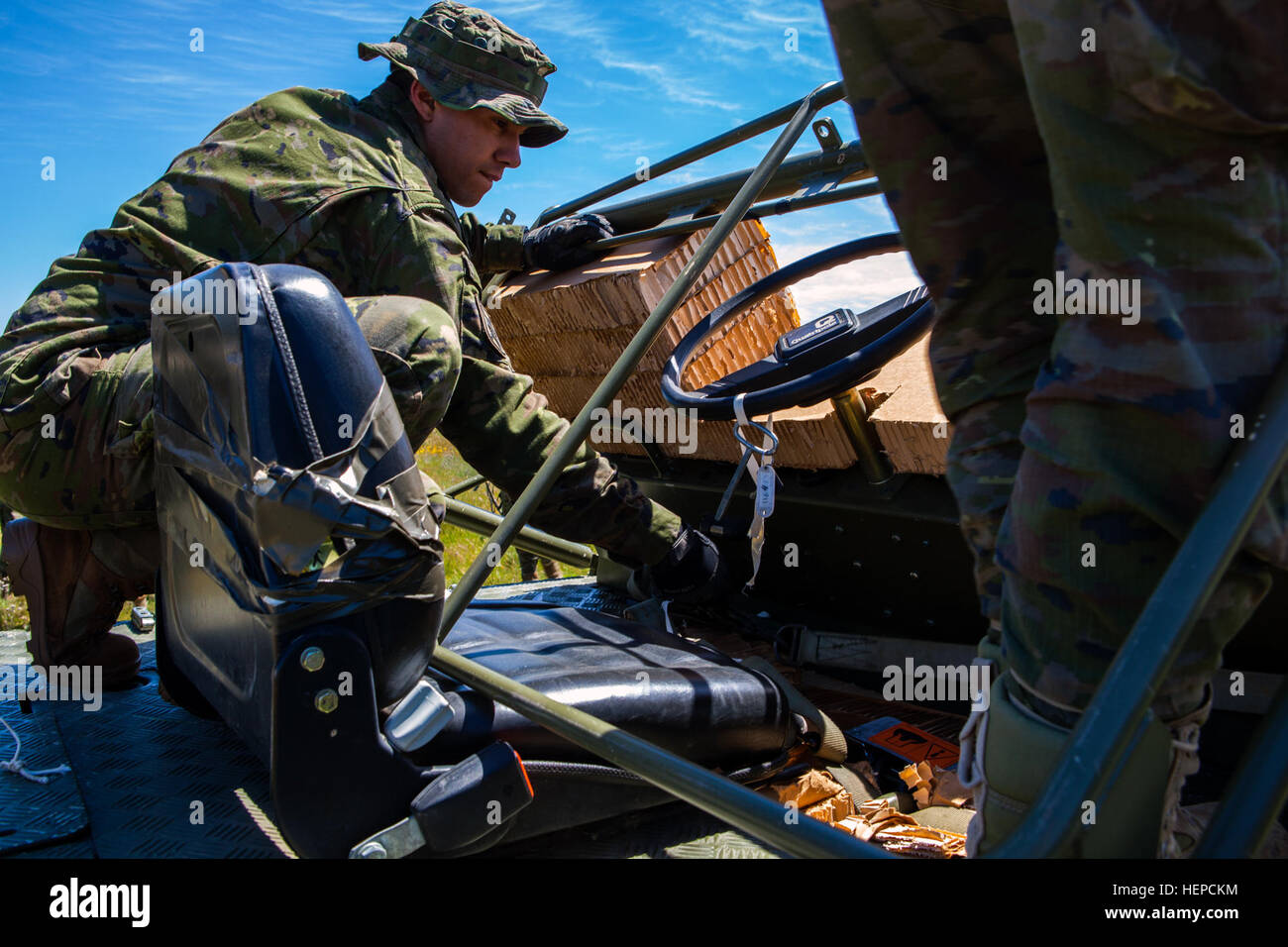 Spanish Soldiers from the Brigada Paracaidista recover a transport vehicle following an airborne cargo drop during Operation Skyfall - España, Madrid, Spain, May 7, 2015.  Operation Skyfall - España is an exercise initiated and organized by the 982nd Combat Camera Company, and hosted by the Brigada Paracaidista of the Spanish army. The exercise is a bilateral subject matter exchange focusing on interoperability of combat camera training and documentation of airborne operations. (U.S. Army photo by Staff Sgt. Justin P. Morelli / Released) Operation Skyfall - Espa%%%%%%%%C3%%%%%%%%B1a 150507-A-P Stock Photo